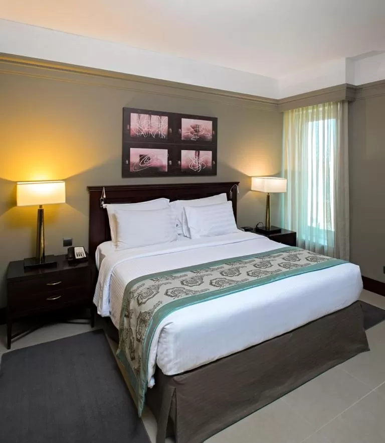 Bed in Somewhere Hotel Apartment