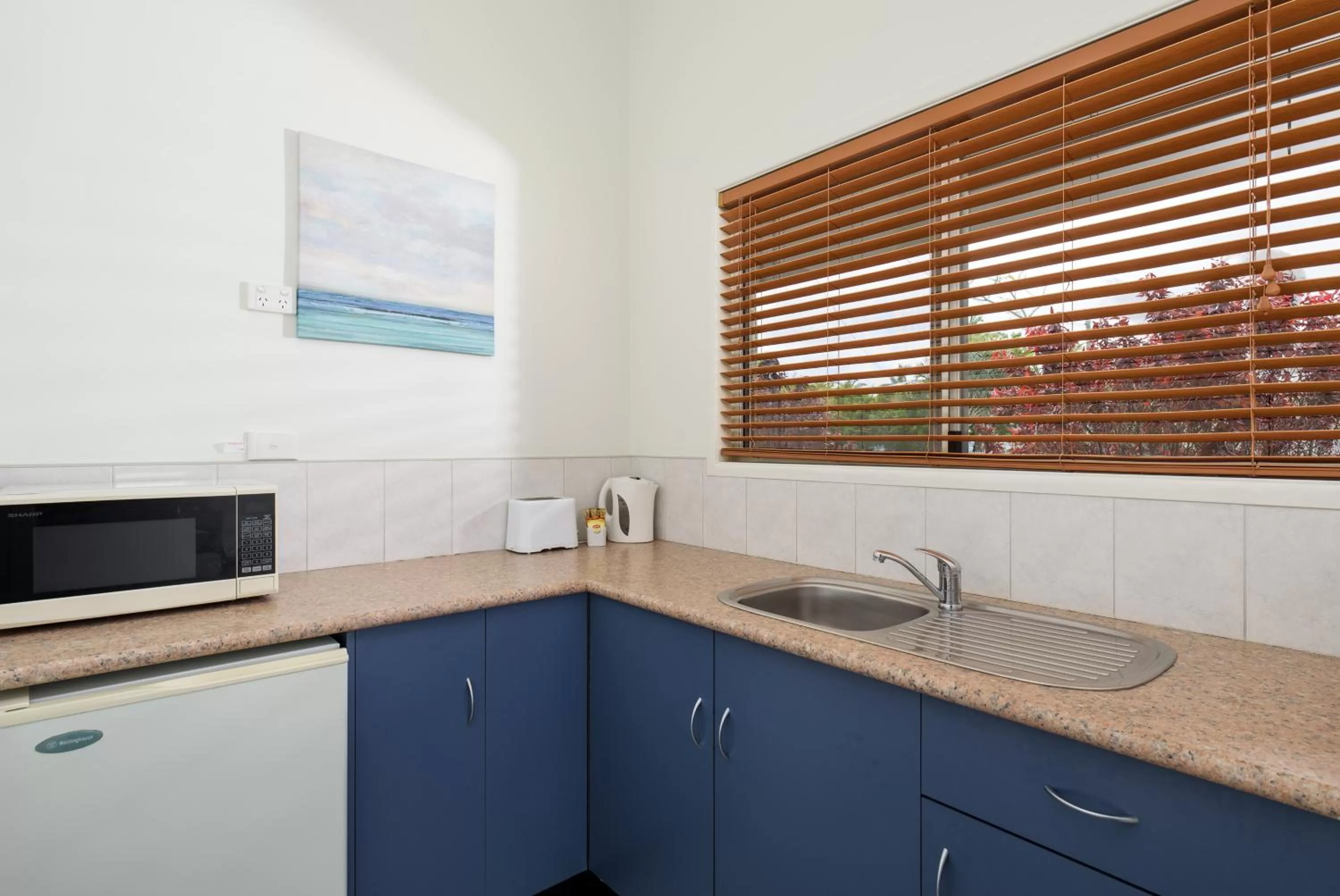 Kitchen or kitchenette in Tin Can Bay's Sleepy Lagoon Motel