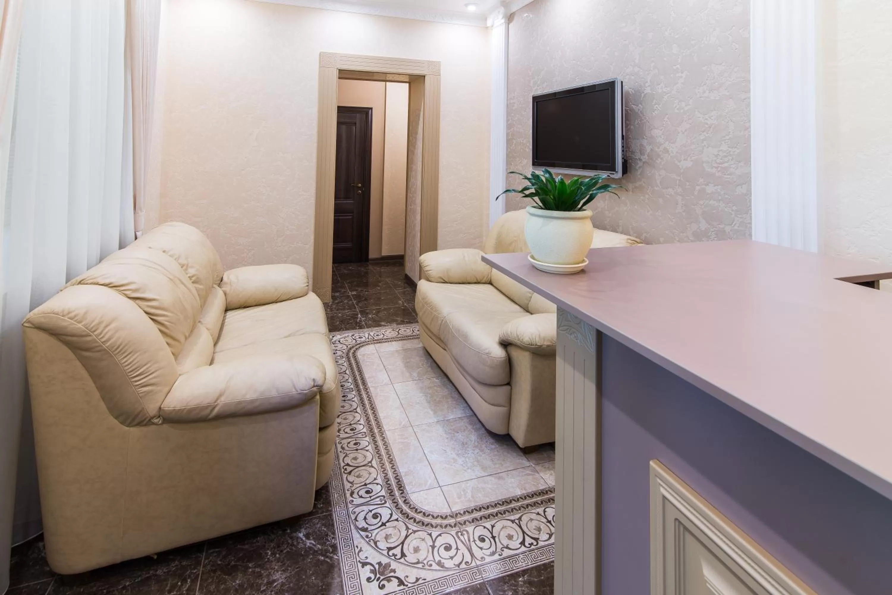 Communal lounge/ TV room in L.O.Y Family Hotel