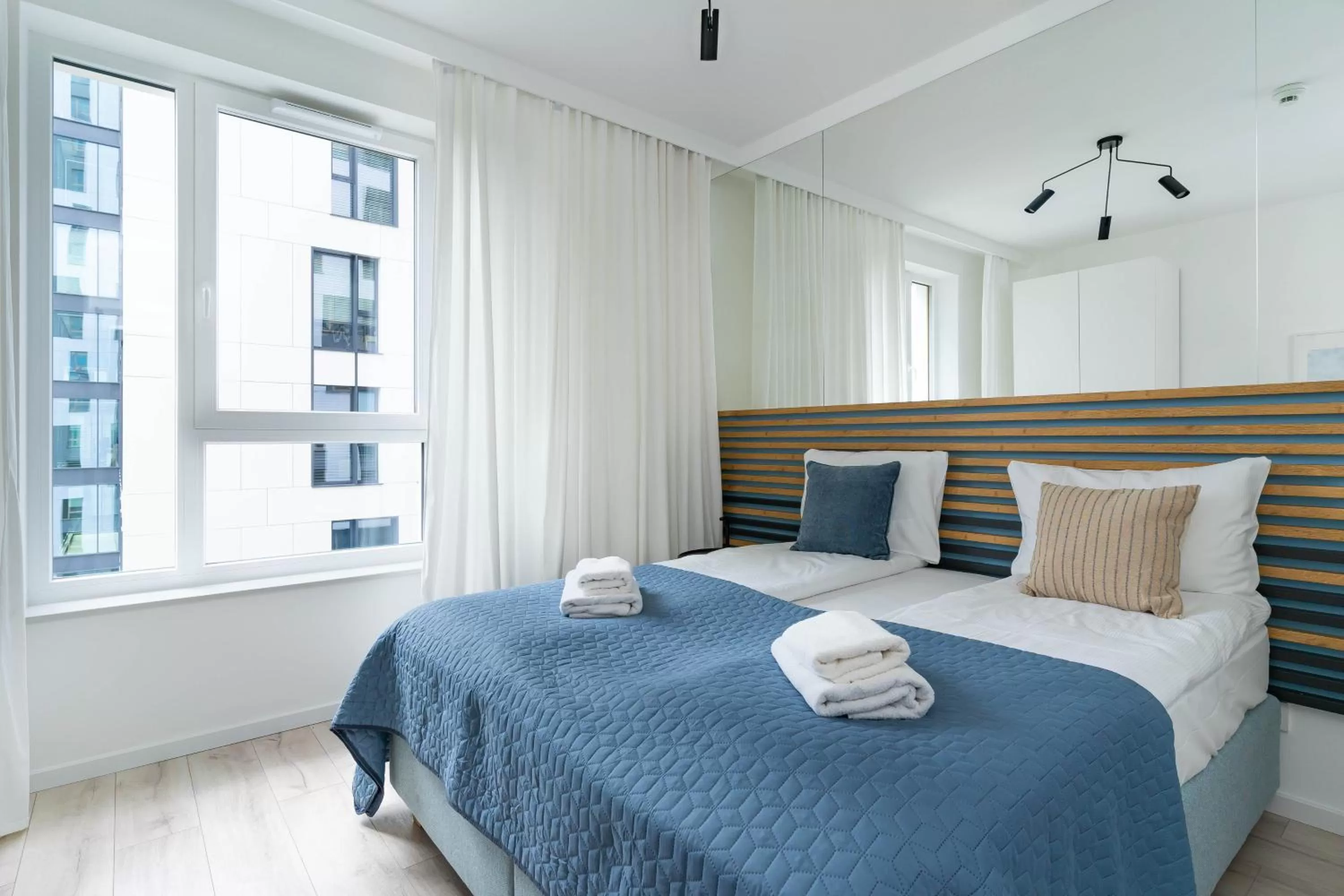 Bed in Symphony Modern Tower Apartamenty