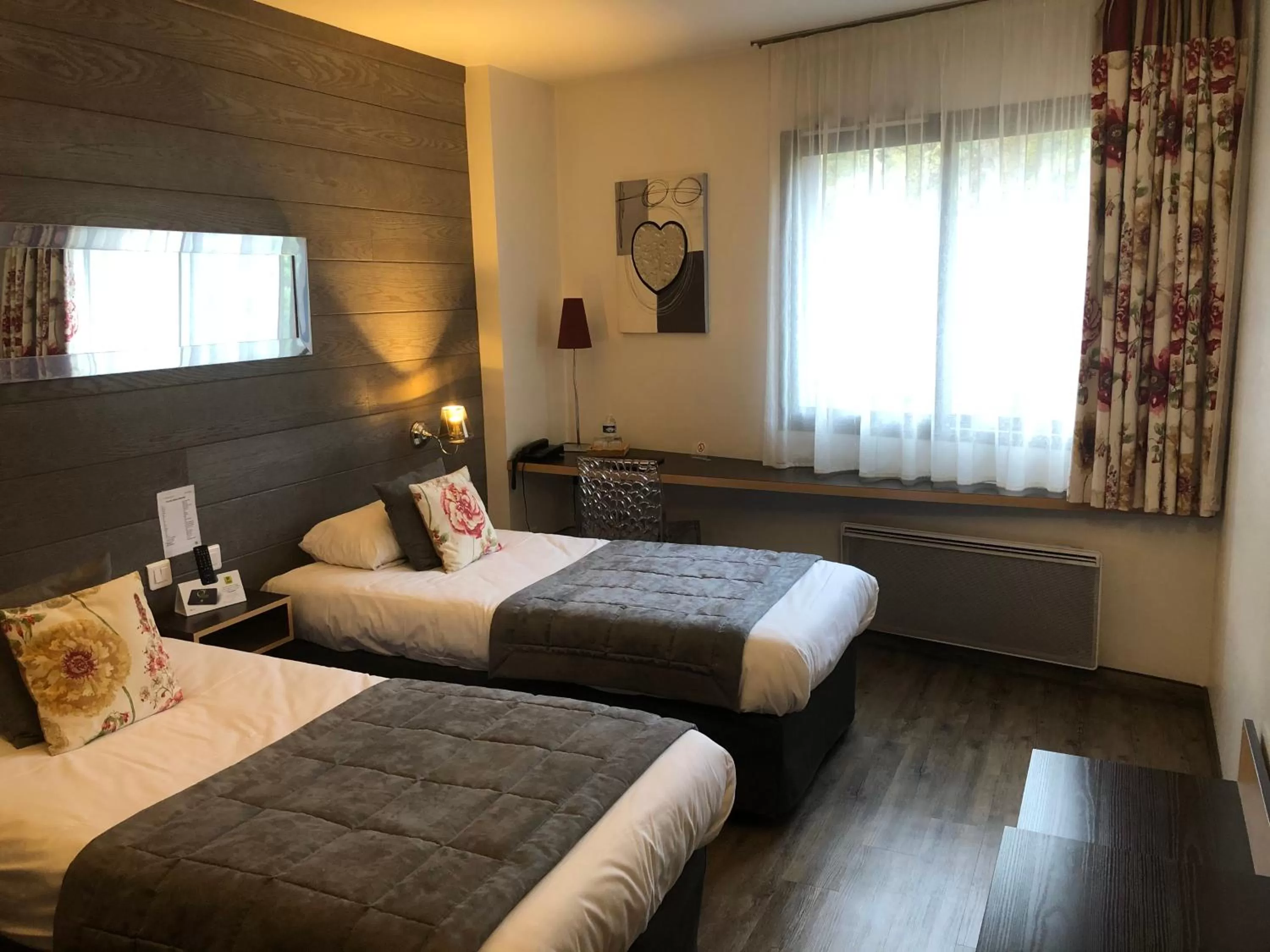 Bed in Logis Hôtel Burnichon