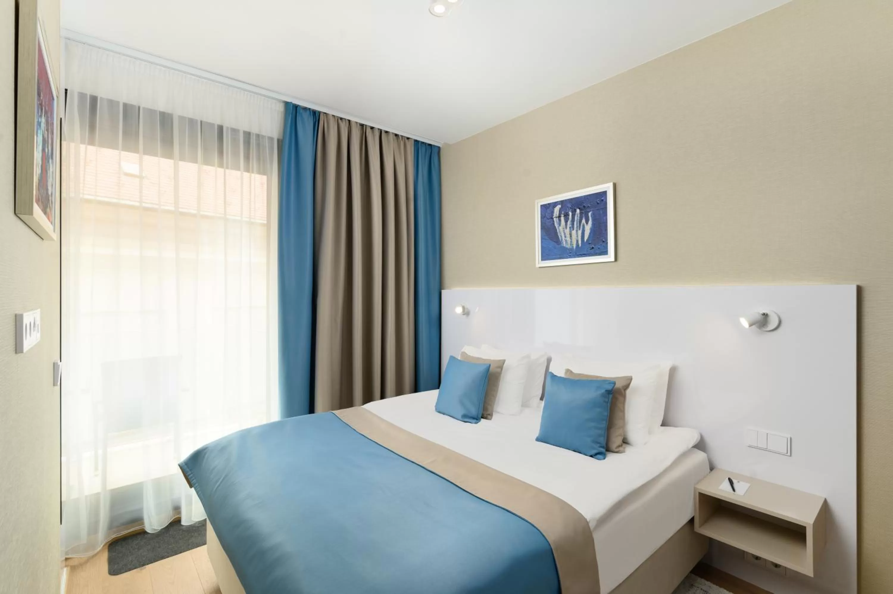 Bed in Emerald Downtown Luxury Suites by Continental Group