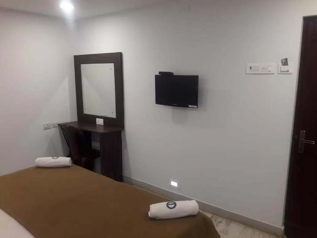 Bed, TV/Entertainment Center in Hotel Ramco Residency A/c
