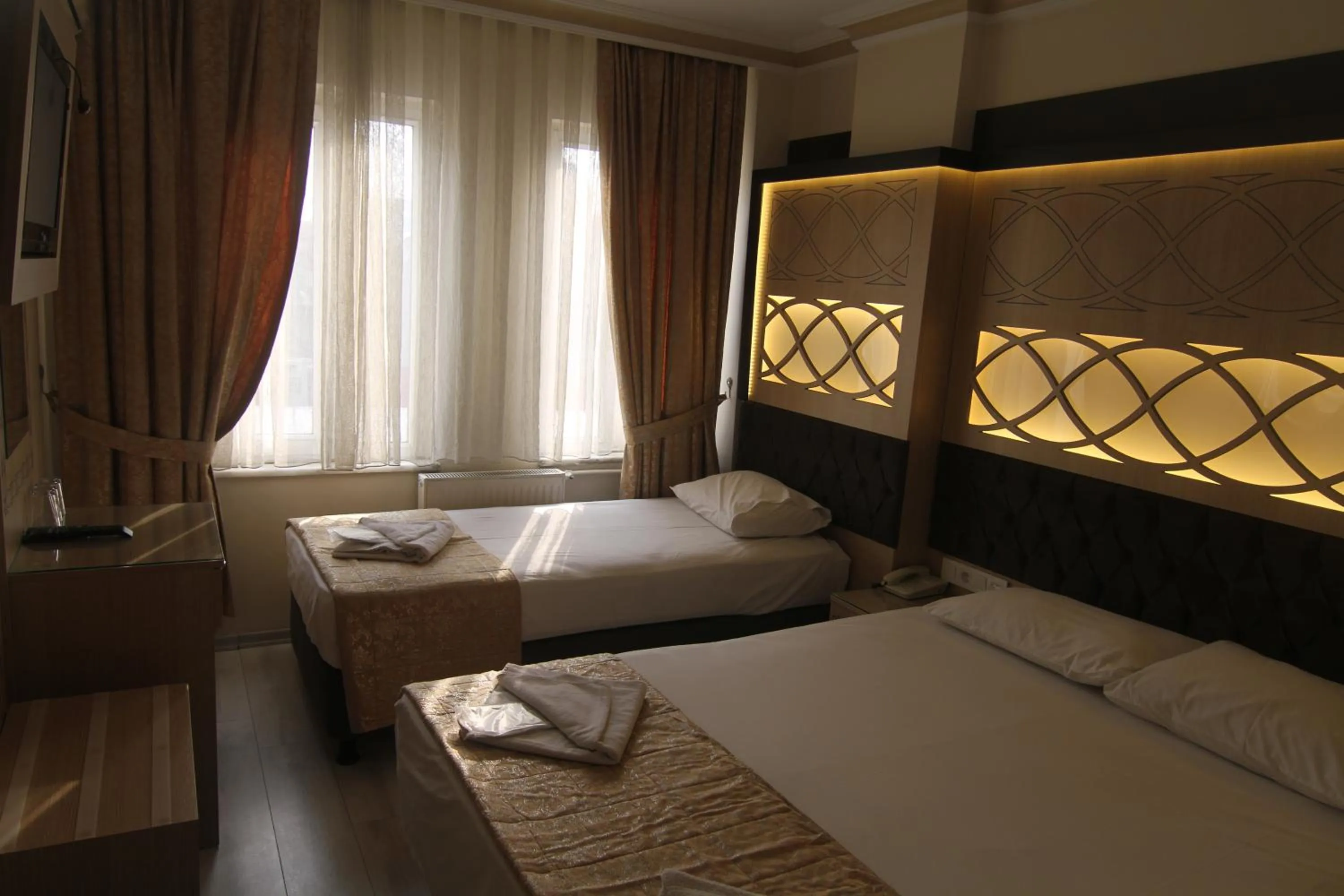 Bed in Grand Liza Hotel