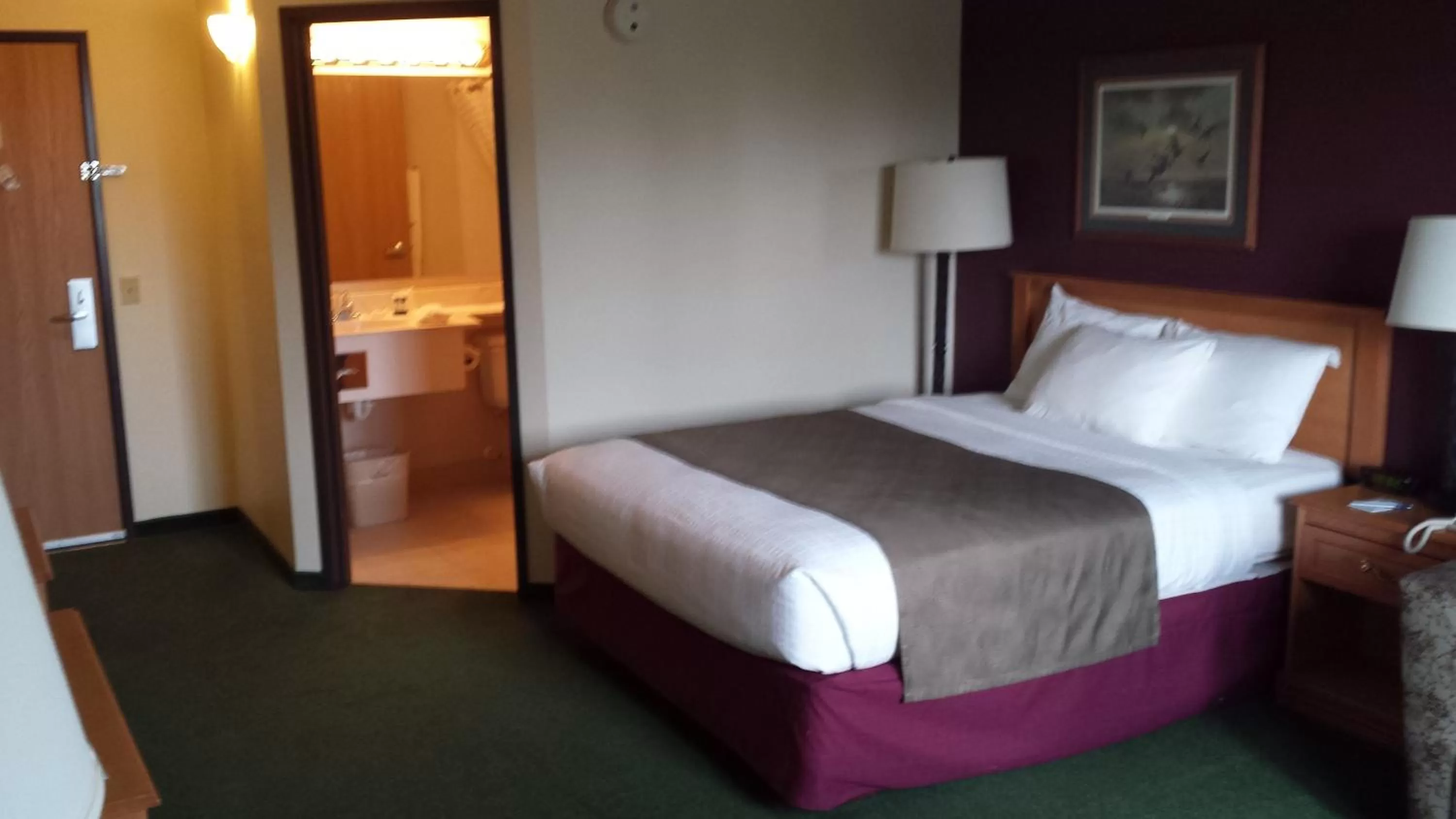 Bed in AmericInn by Wyndham Madison SD