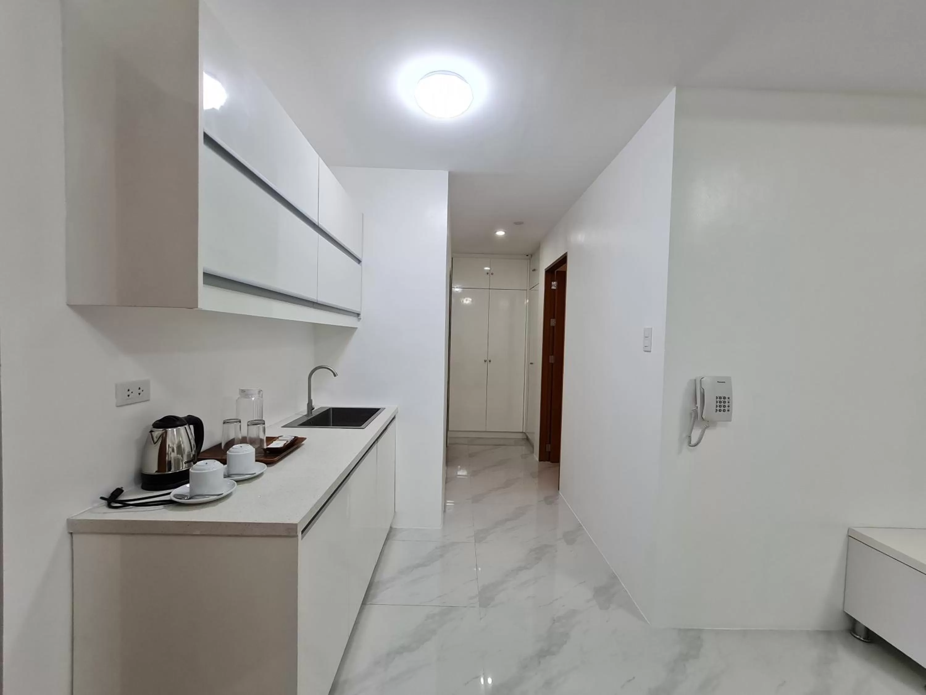 Kitchen or kitchenette in Staycation Hotel