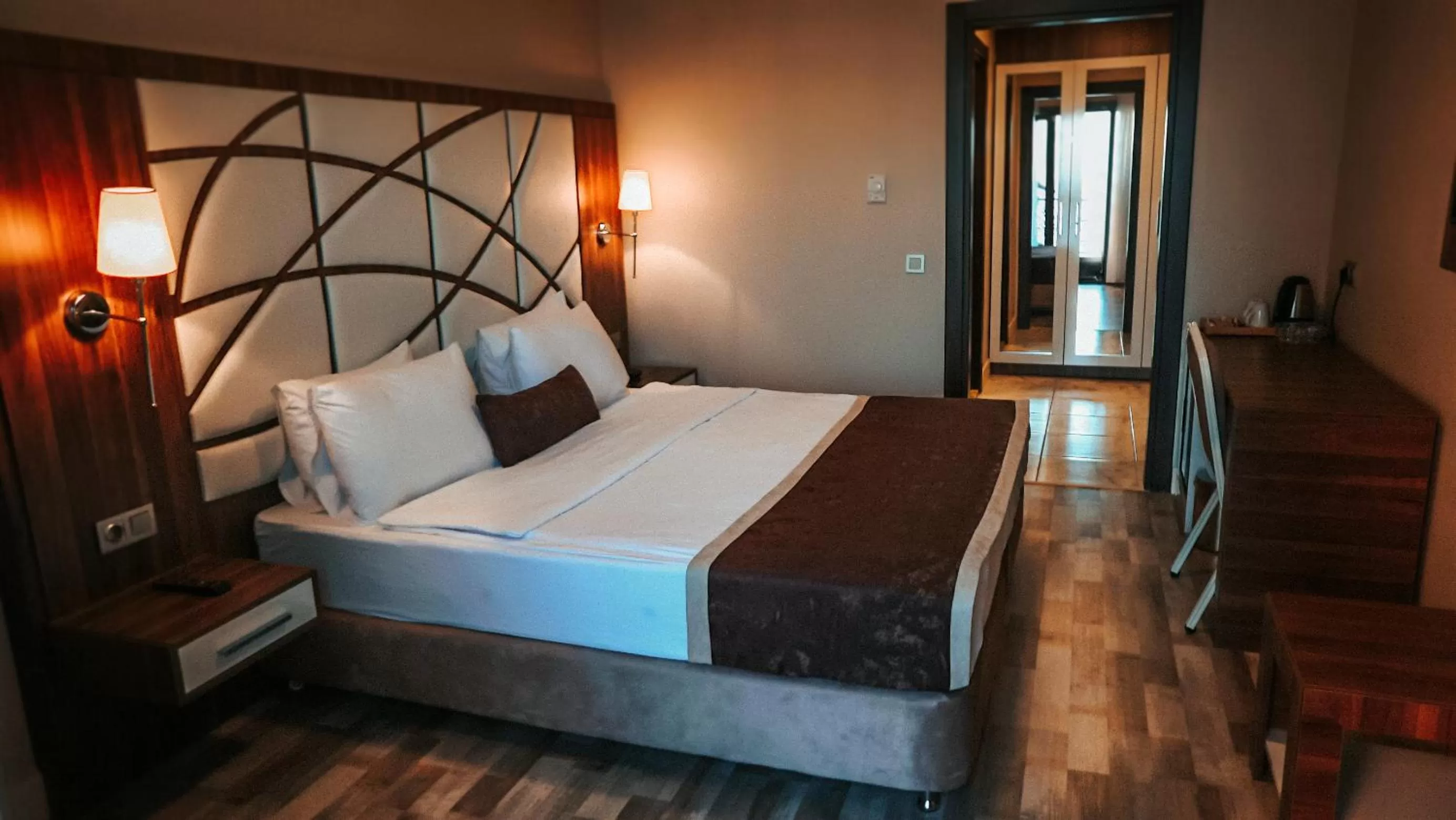 Bed in The Grand Mira Business Hotel