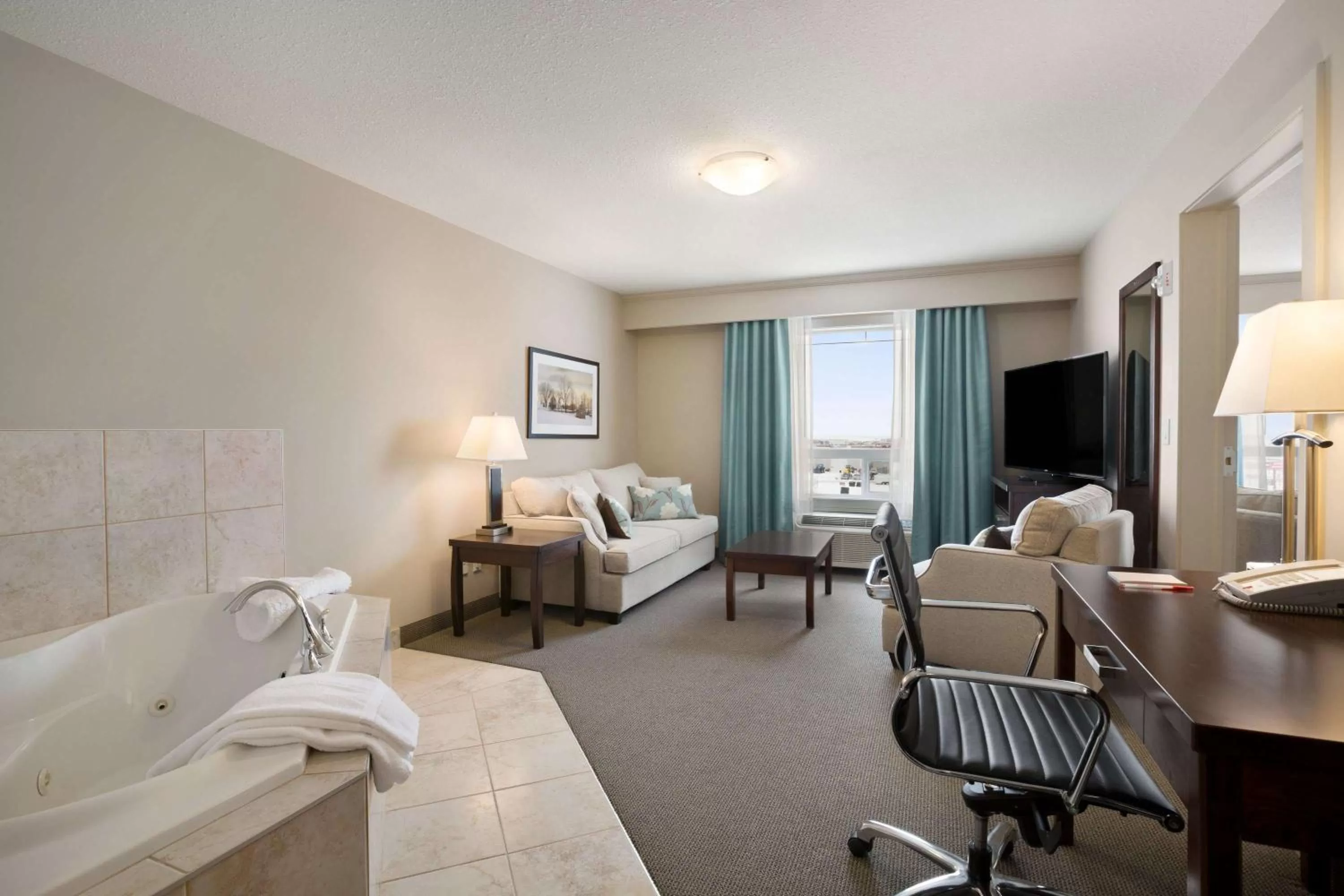 Photo of the whole room, Bed in Ramada by Wyndham Emerald Park/Regina East