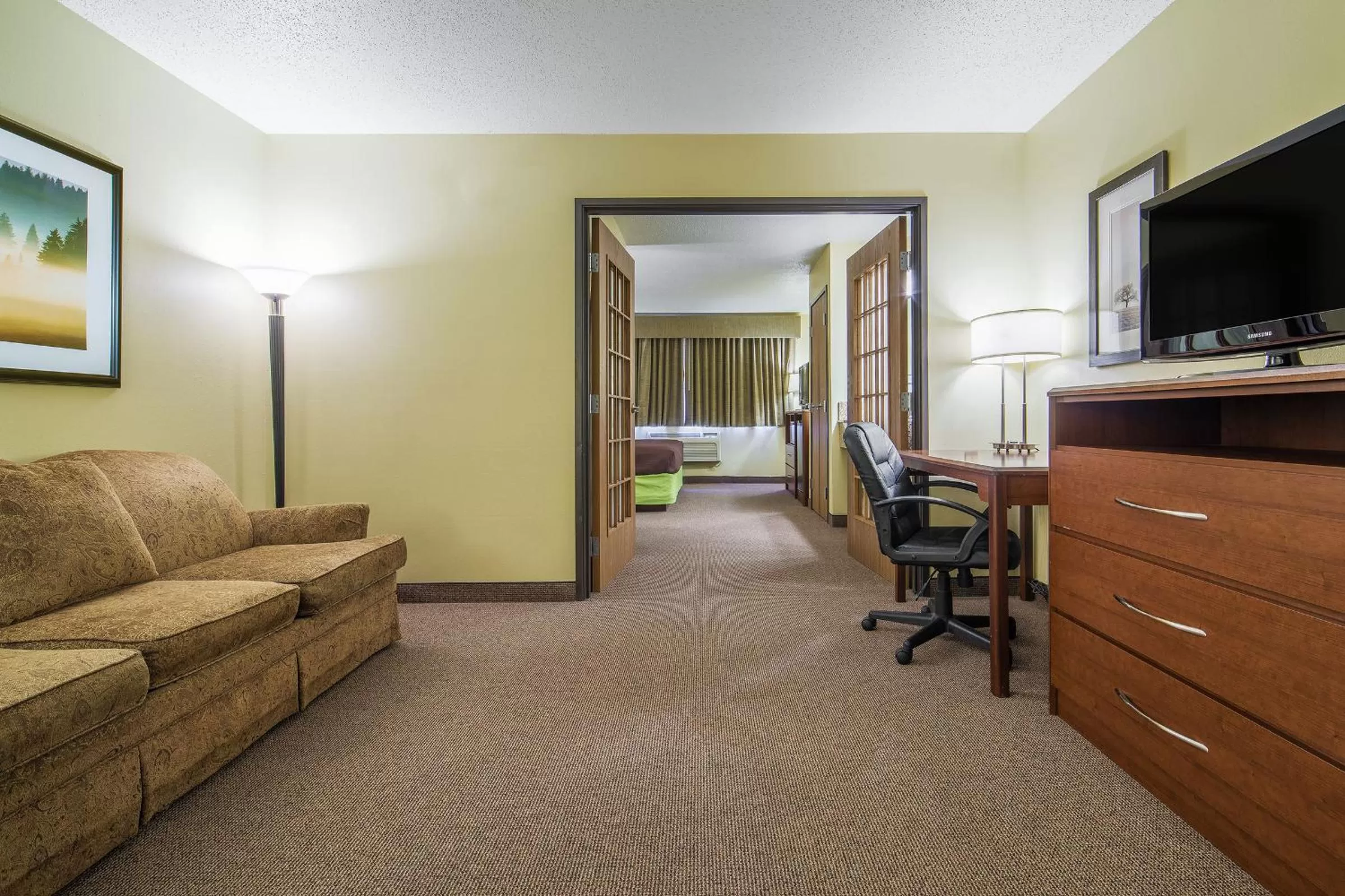 Bed in AmericInn by Wyndham Sioux Falls