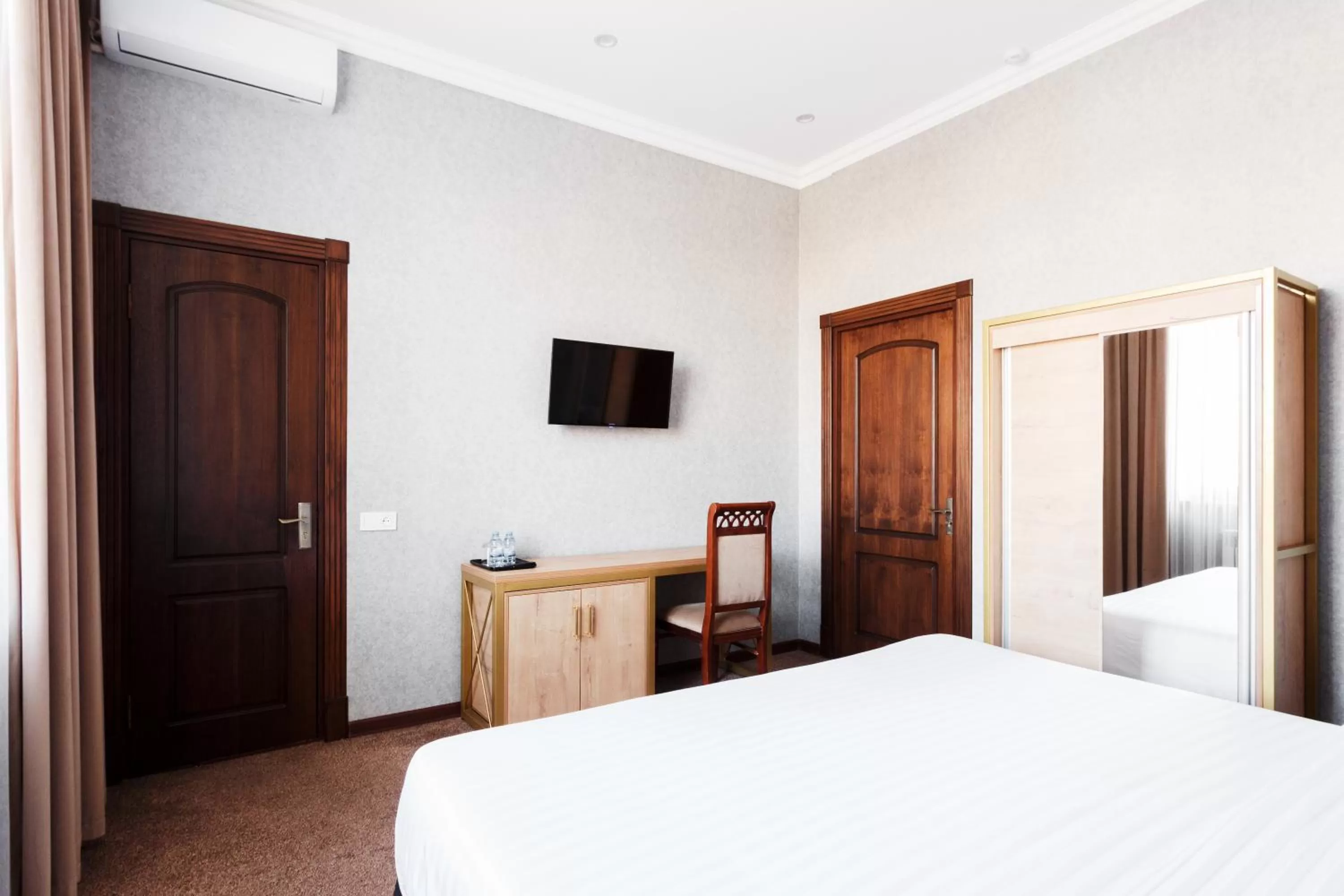 Bed in Western Suites Hotel