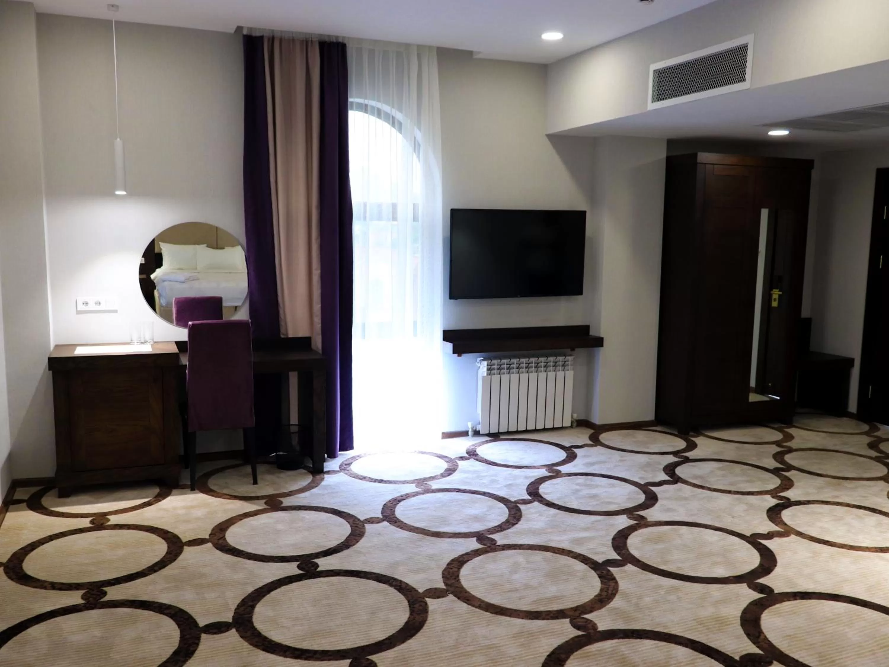 Photo of the whole room, TV/Entertainment Center in East Palace Hotel