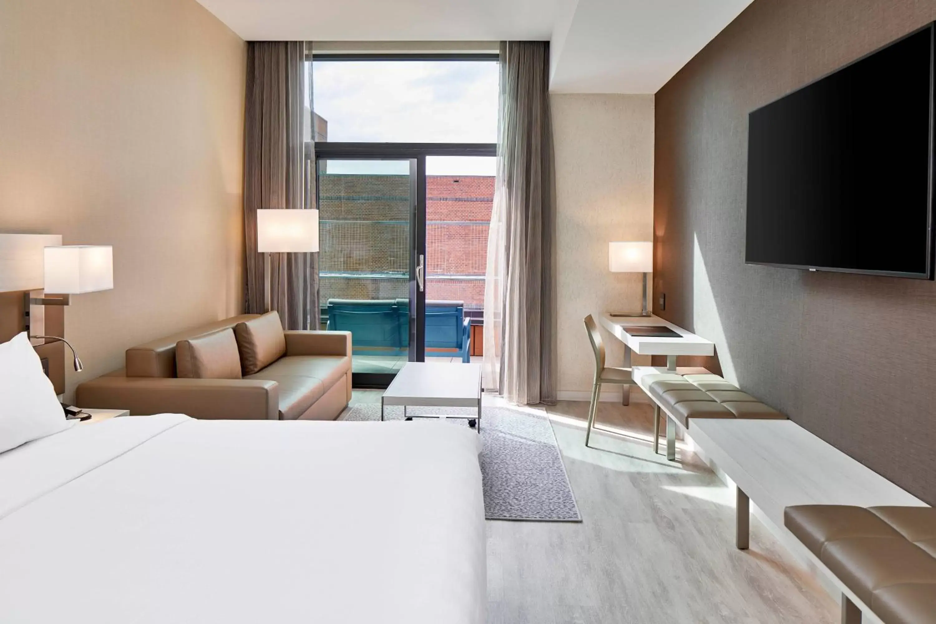 Guest room with king bed, sofa bed, balcony and city view in AC Hotel by Marriott Greenville Guest room with king bed, sofa bed, balcony and city view in AC Hotel by Marriott Greenville