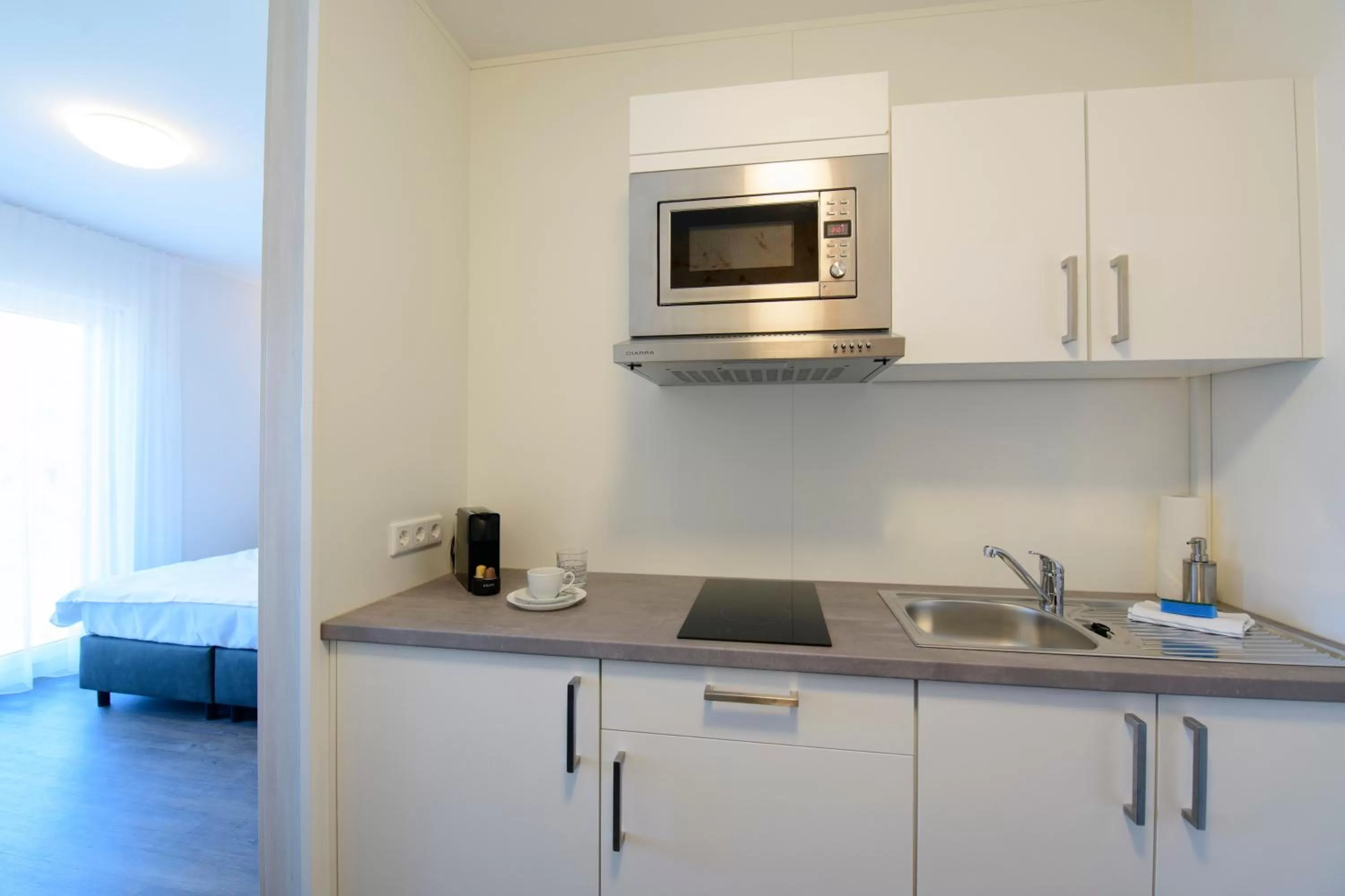 Kitchen or kitchenette in Smart & Stay Aparthotel Saarbrücken Süd - Self-Check-In - Free Parking