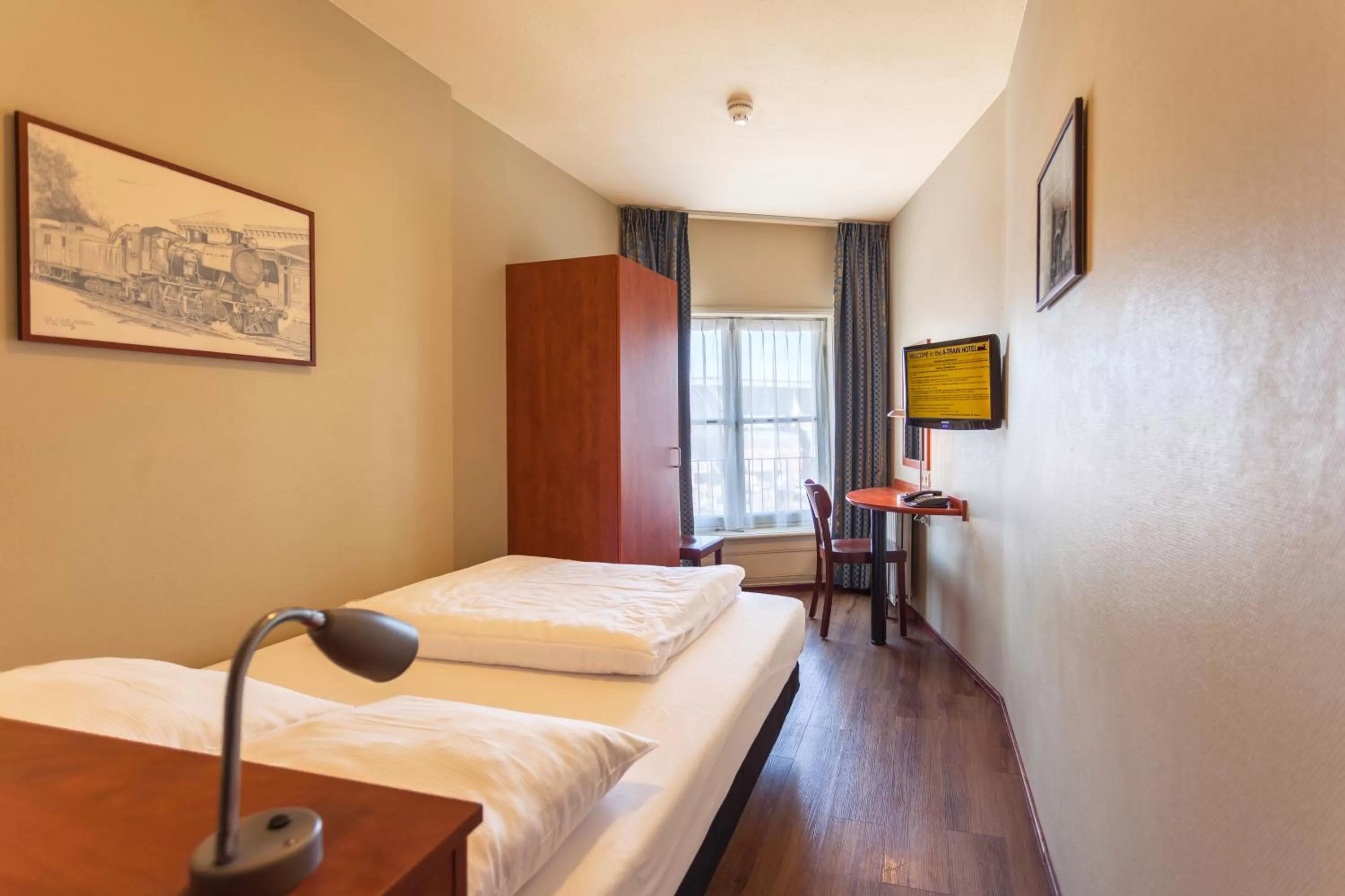 Bed in A-Train Hotel