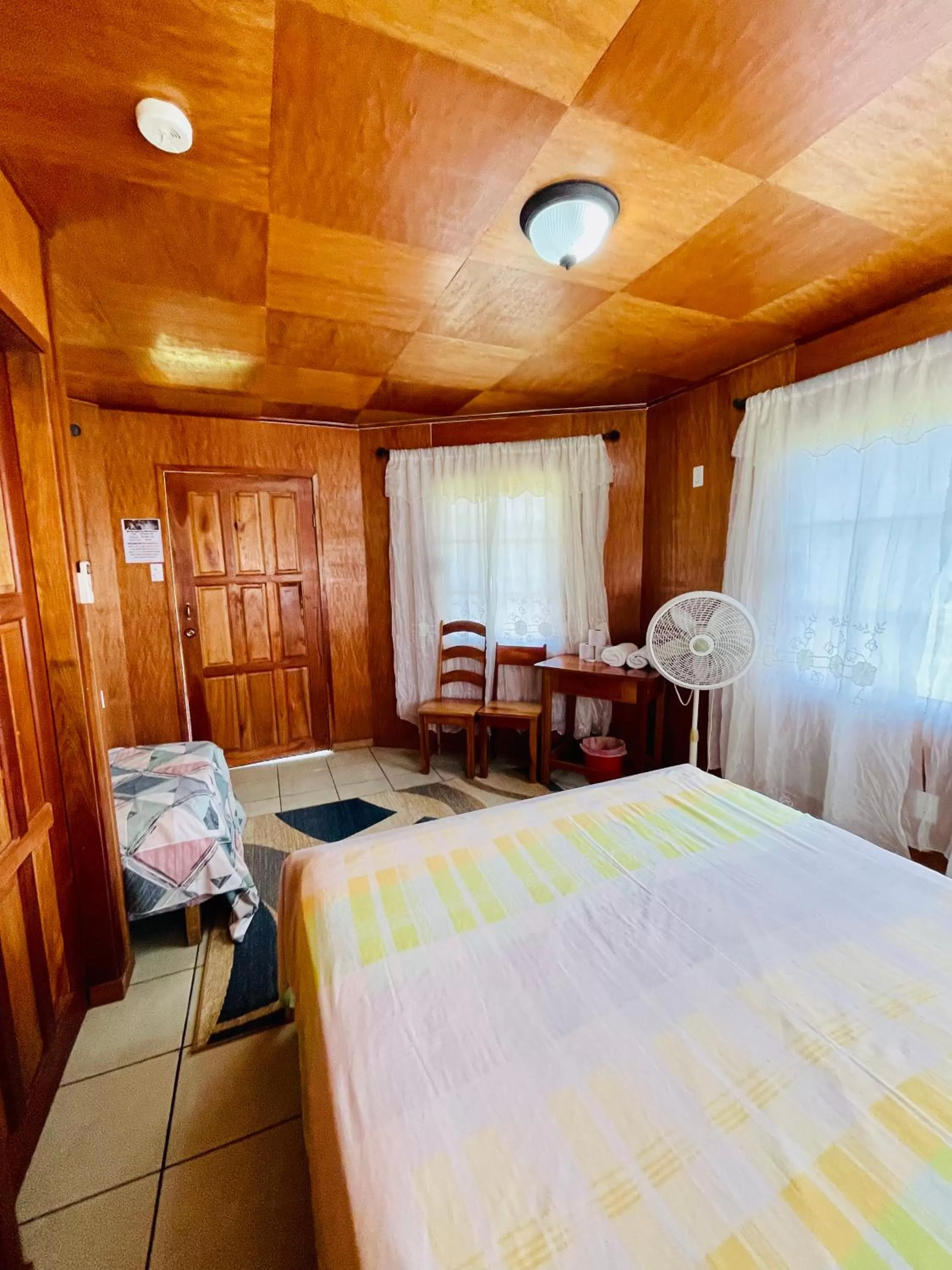 Bed in Lamanai Riverside Retreat