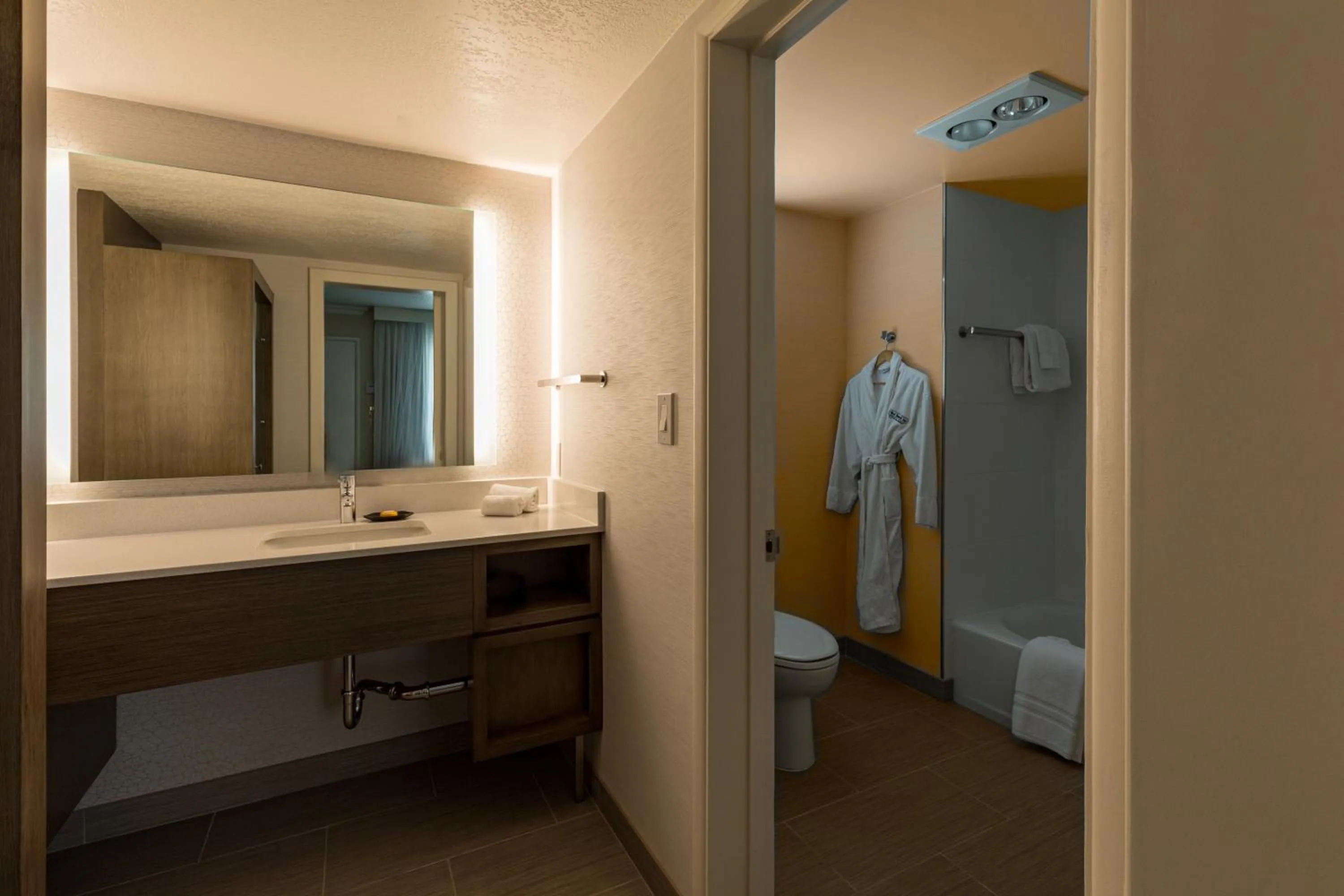 Bathroom, Bed in West Beach Inn, a Coast Hotel