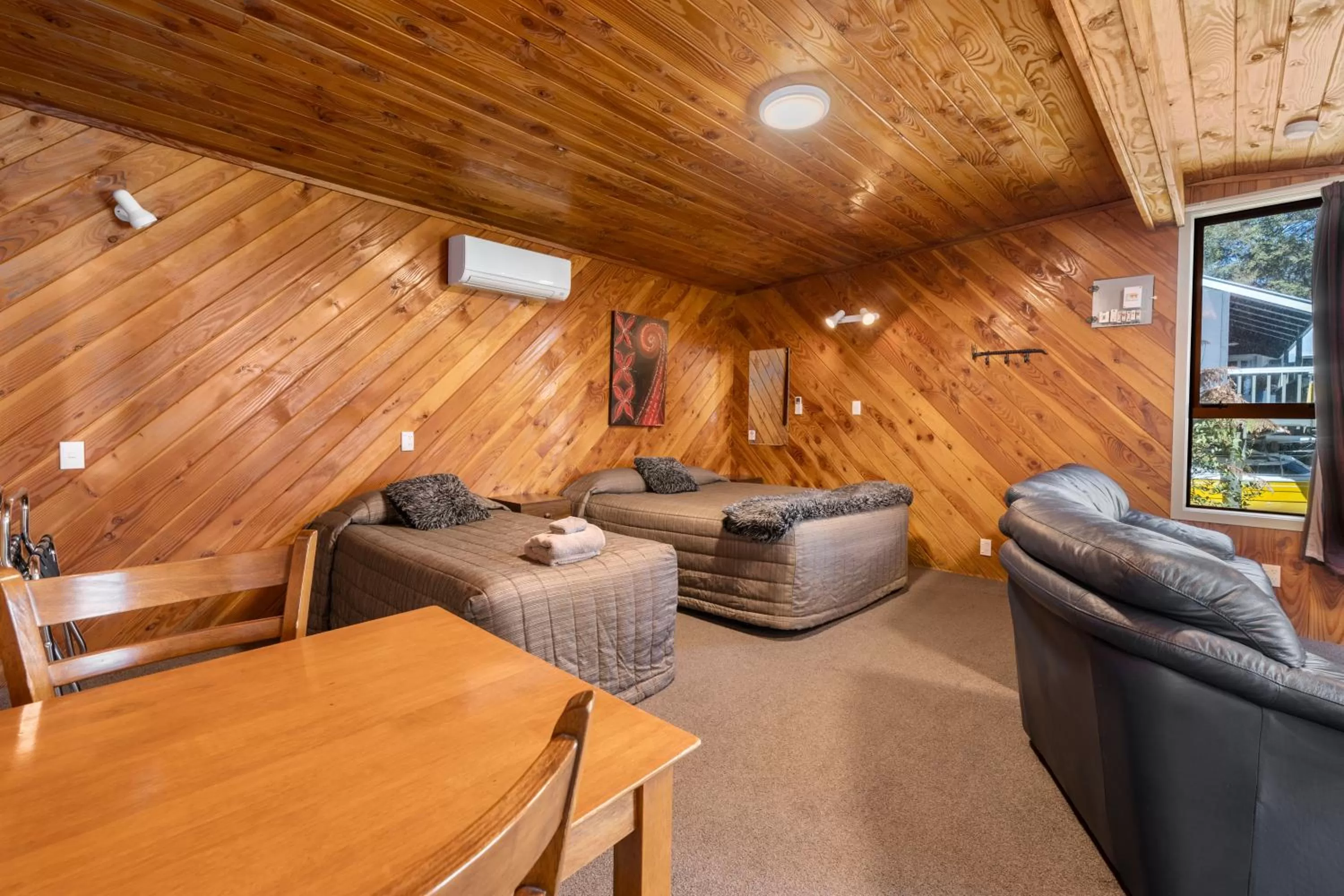 Bed, Seating Area in Sportsmans Lodge Turangi