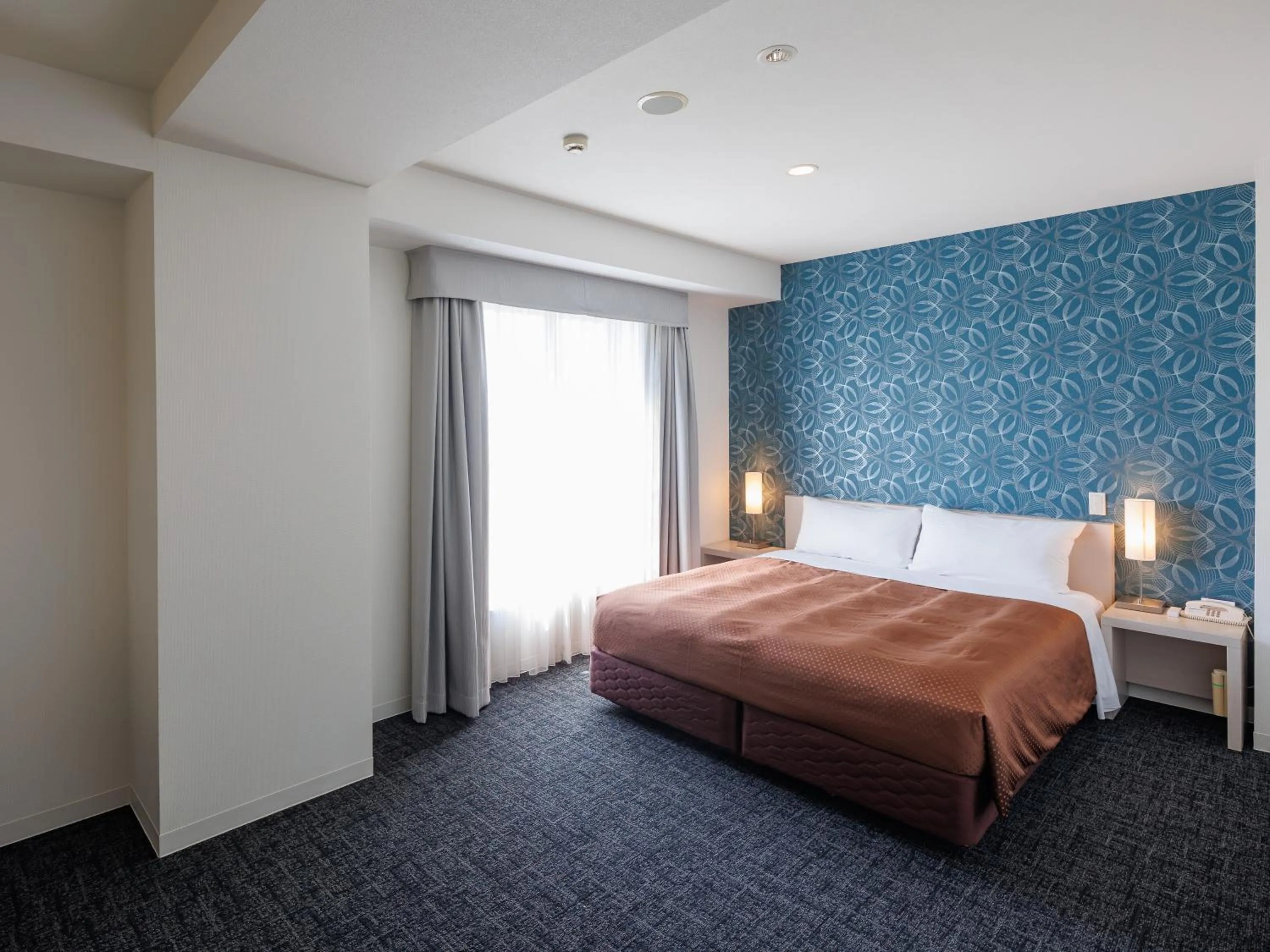 Bed in J Hotel Rinku