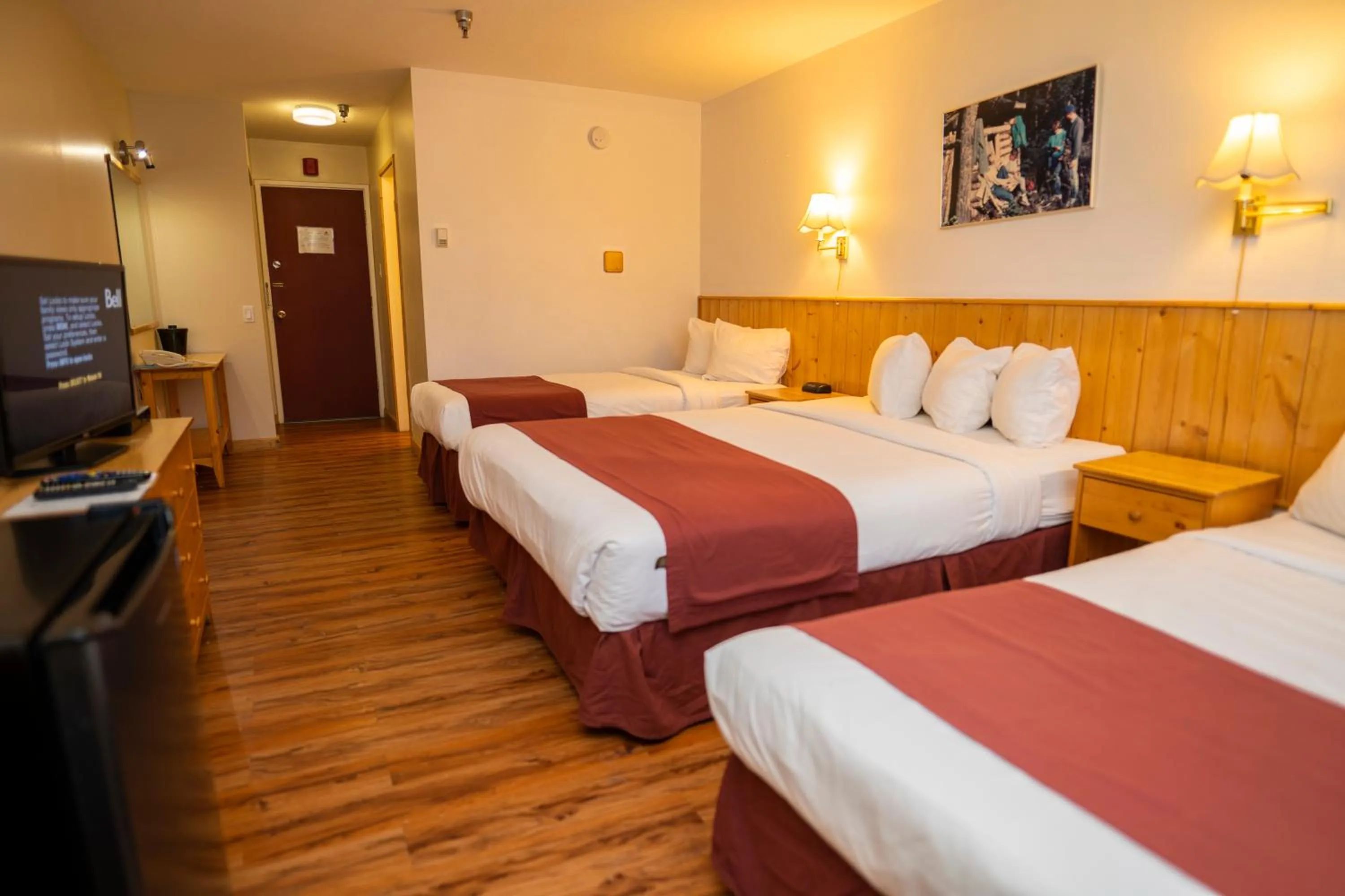 Bed in Canadas Best Value Inn- Riverview Hotel