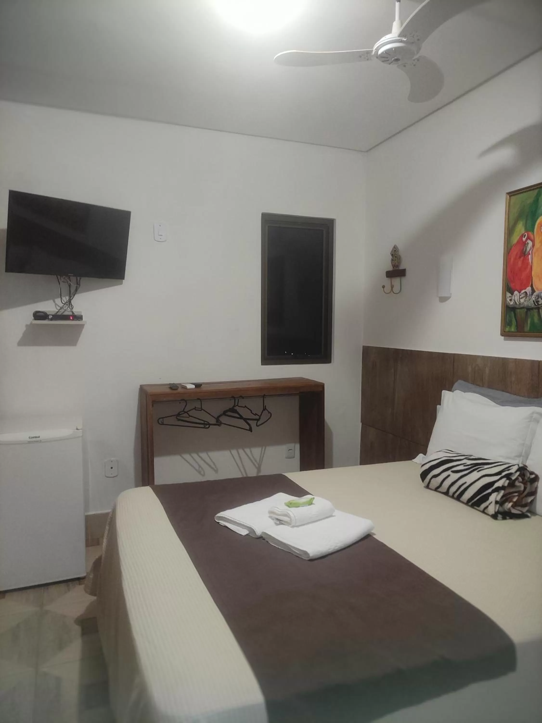 Bed in Pousada da Gi Suítes e Turismo