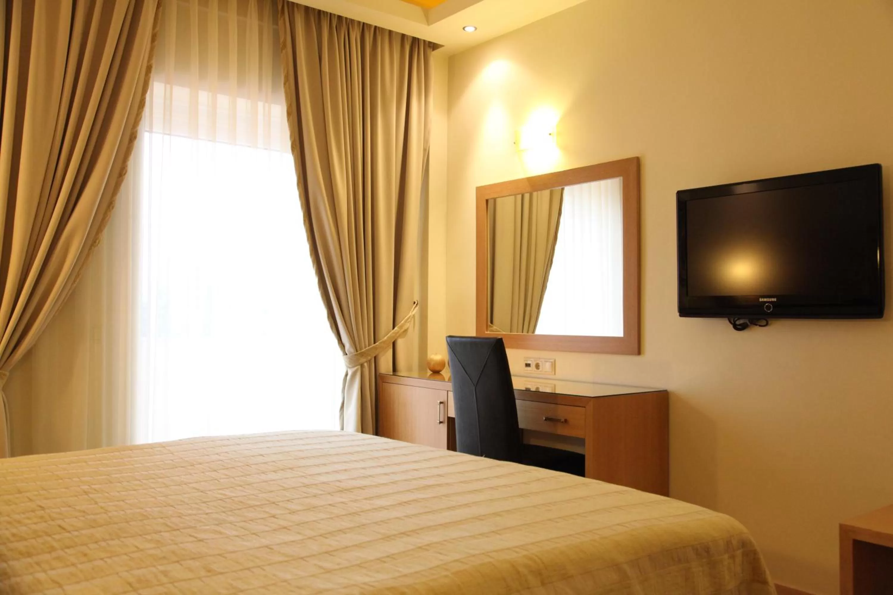 Seating area, Bed in Pantelidis Hotel & Spa