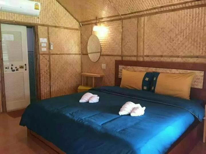Bed in Bamboo House Resort