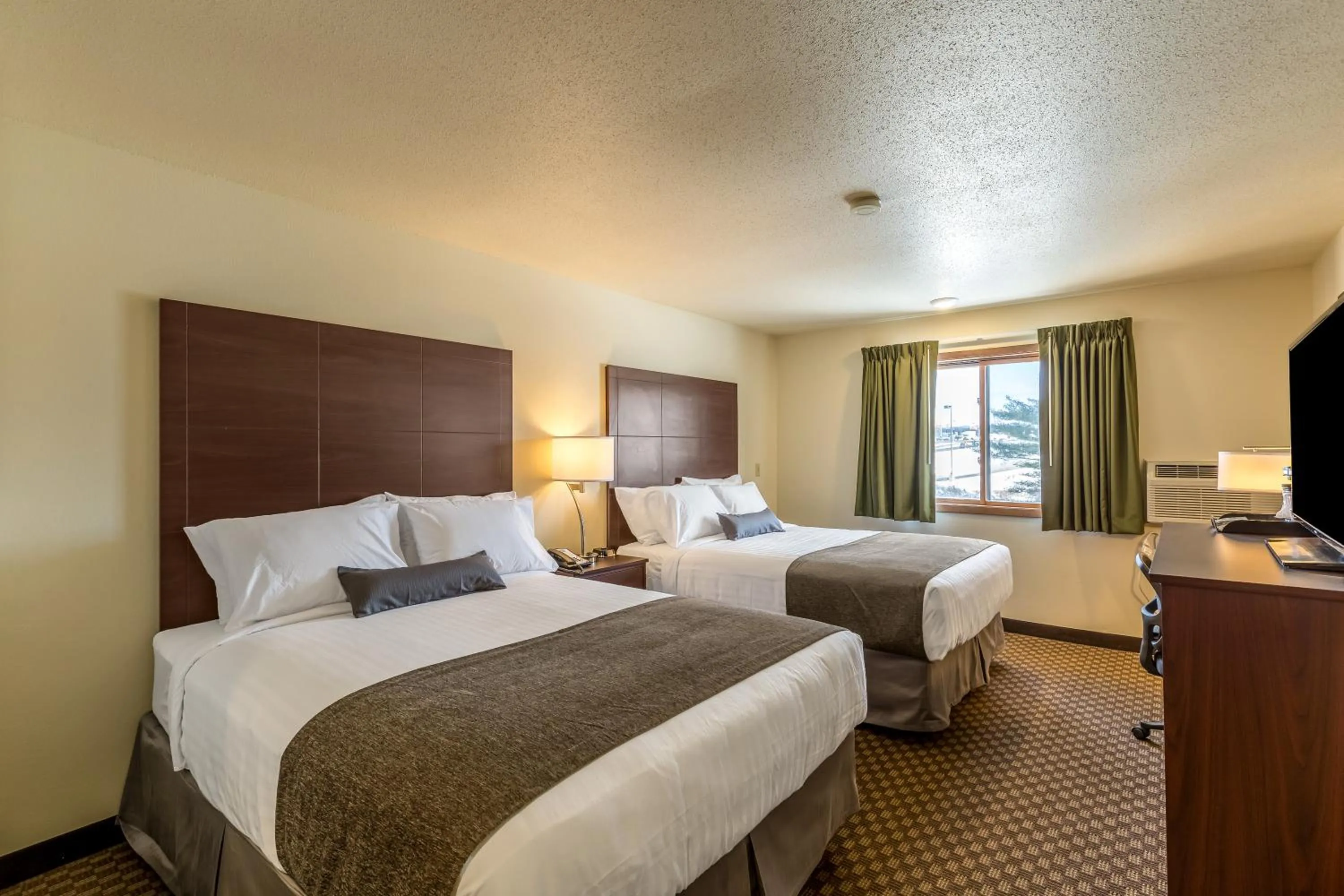 Bed in Cobblestone Inn & Suites - Merrill