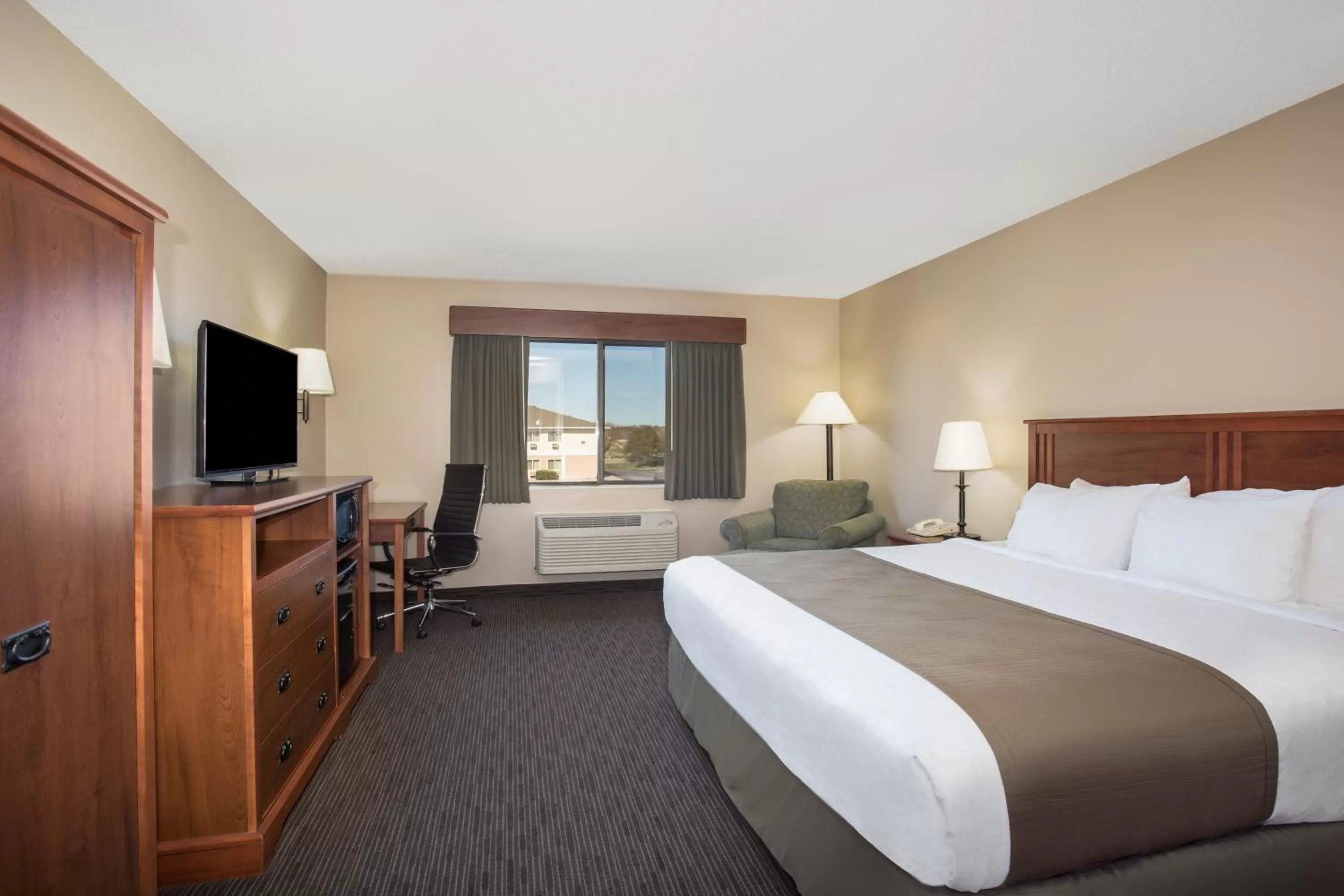 Bed in AmericInn by Wyndham Sioux City