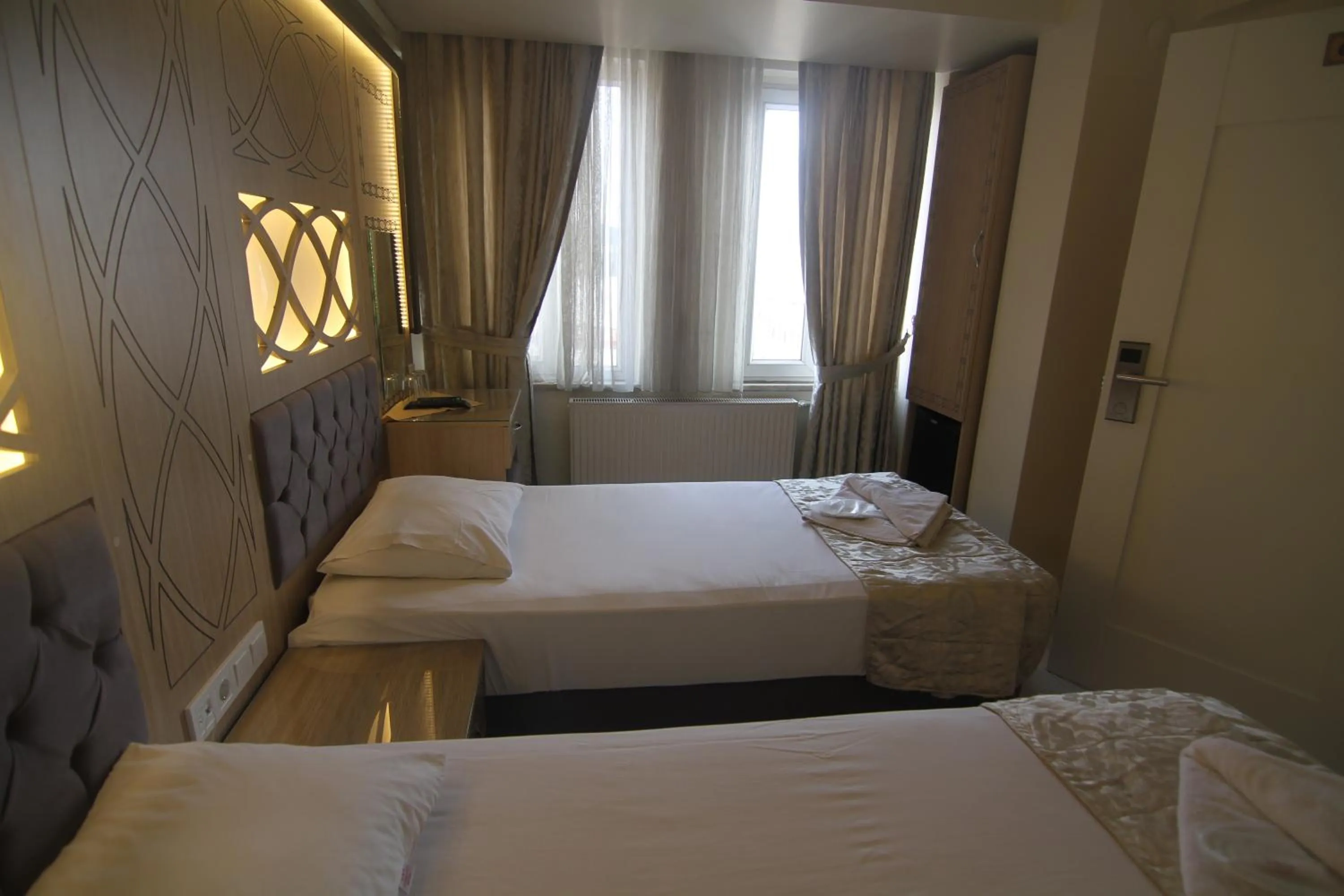 Bed in Grand Liza Hotel