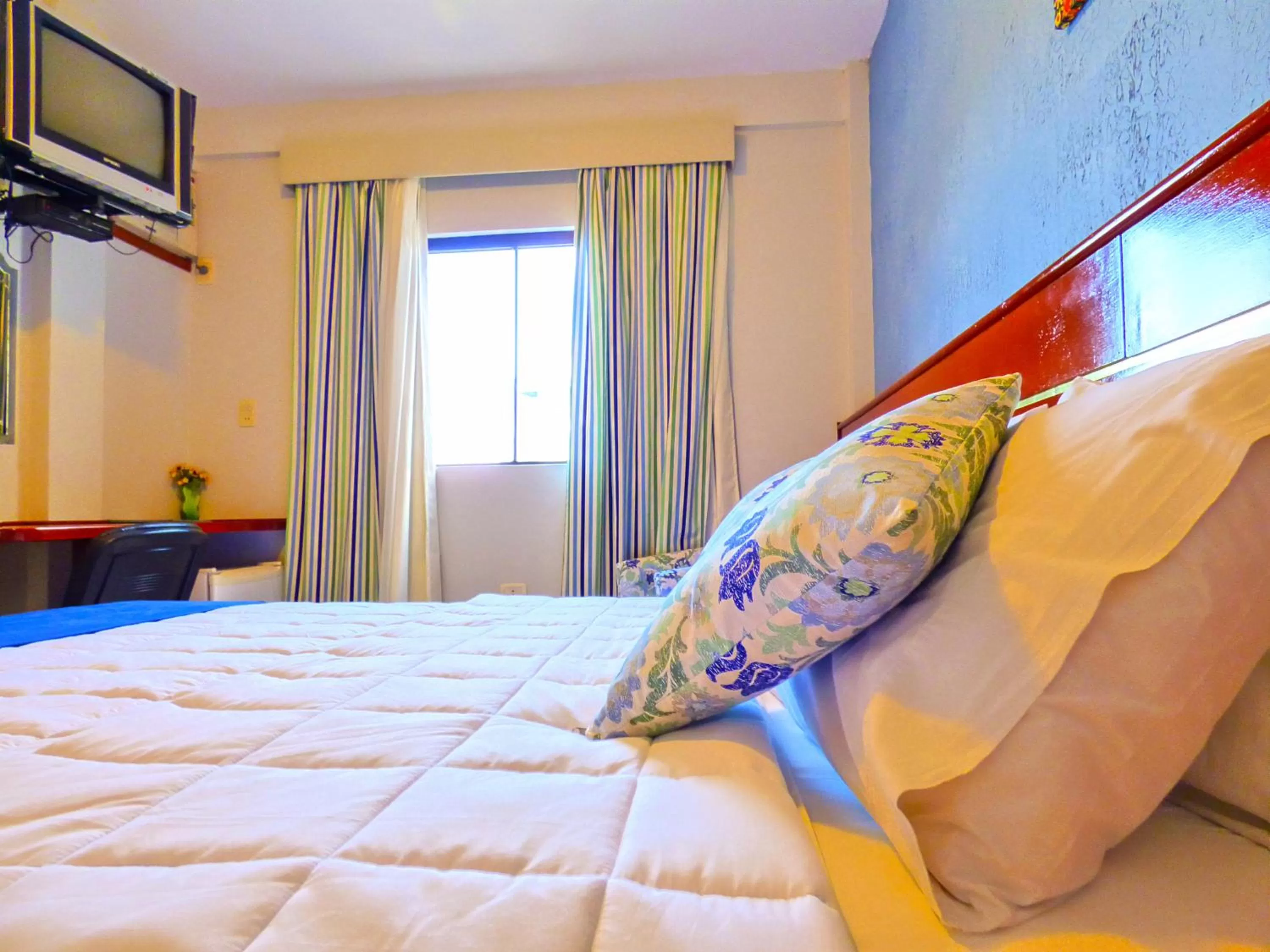 Bed in De La Costa Hotel