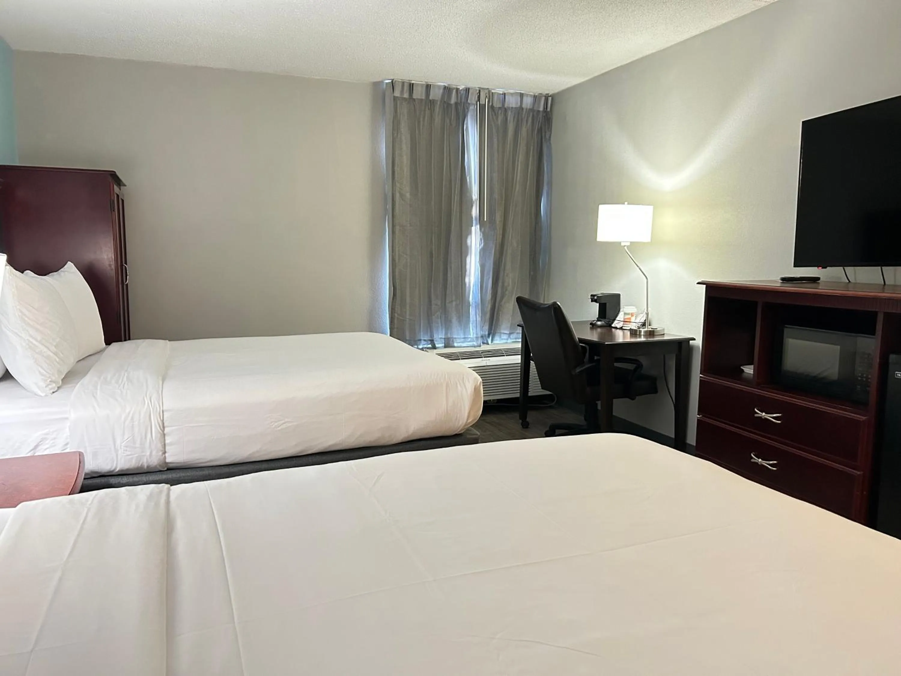 Bed in Clarion Inn & Suites Grand Rapids Airport