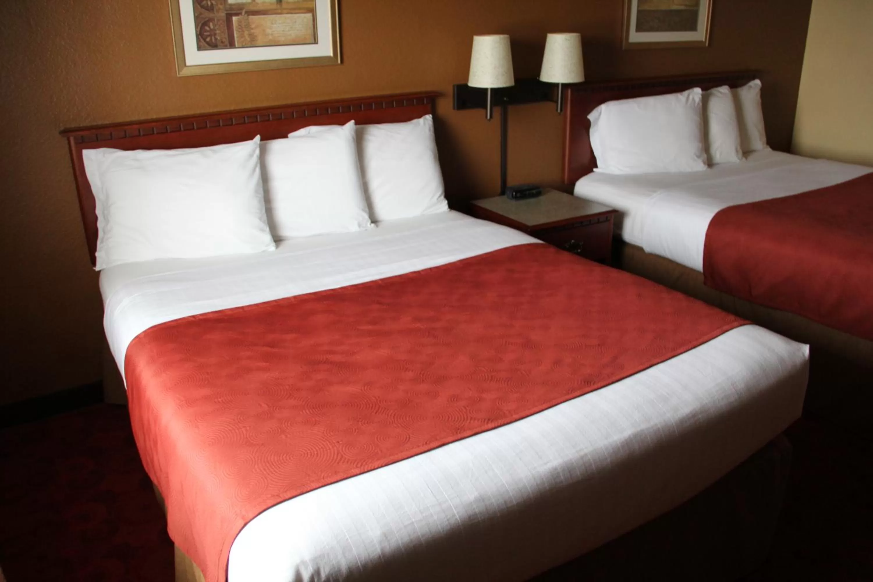 Bed in AmericInn by Wyndham West Bend