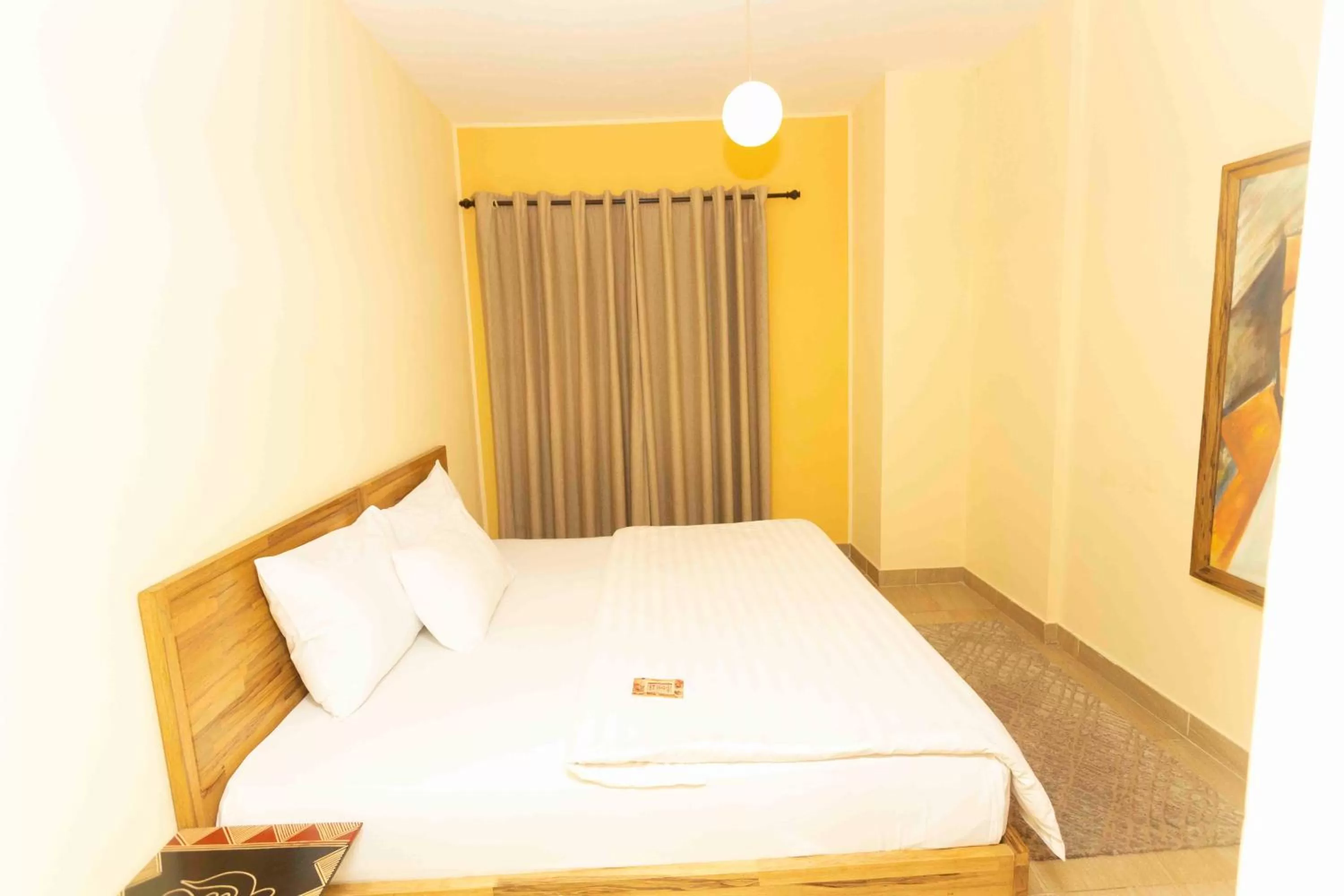 Bed in Roots Hotel Apartment