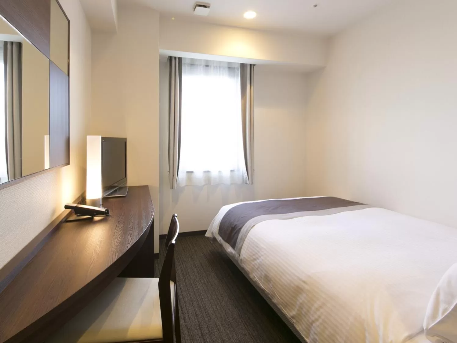 Bed in Urban Hotel Minami Kusatsu