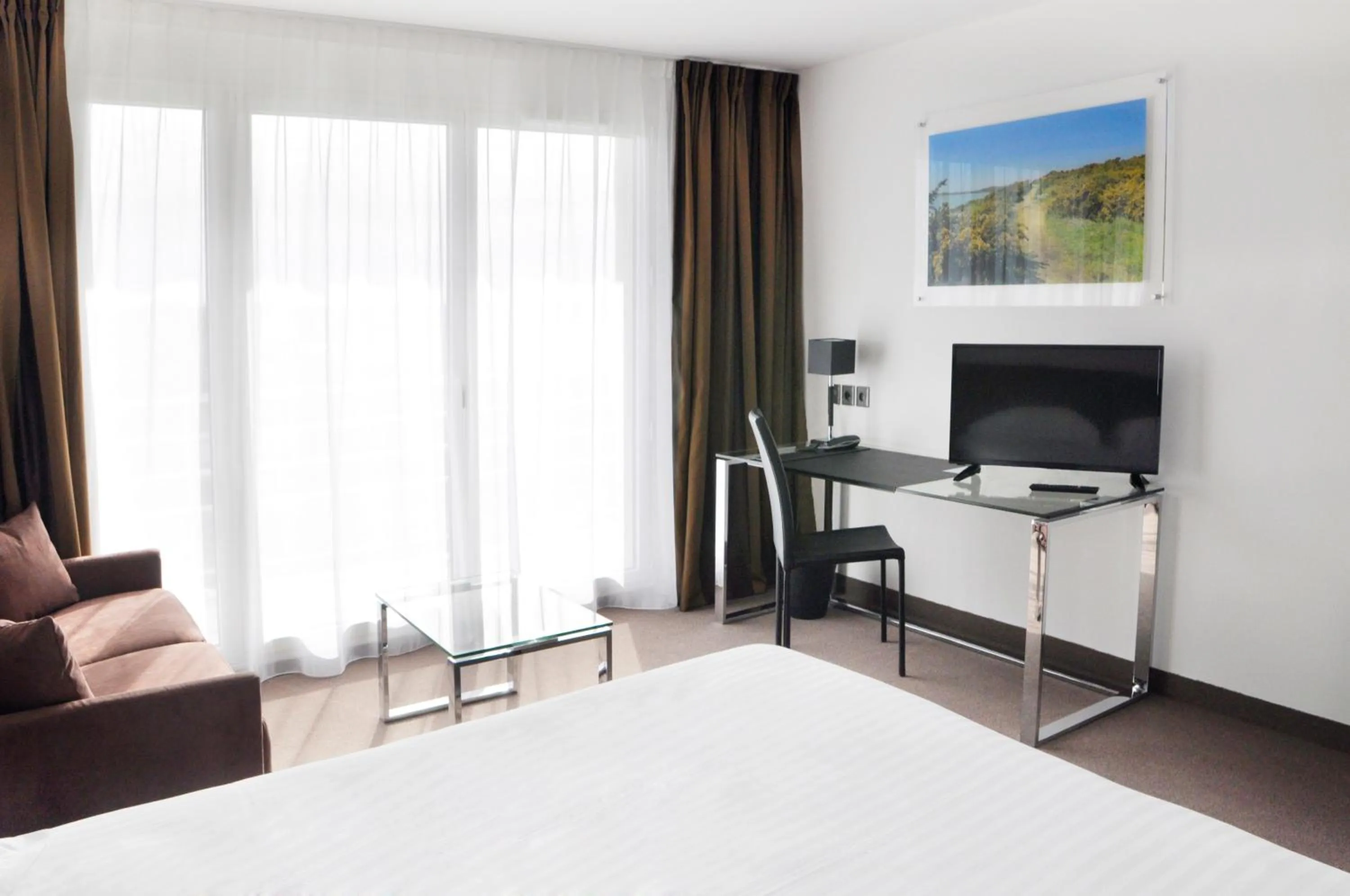 Seating area, Bed in Golden Tulip La Baule Hotel and Residence