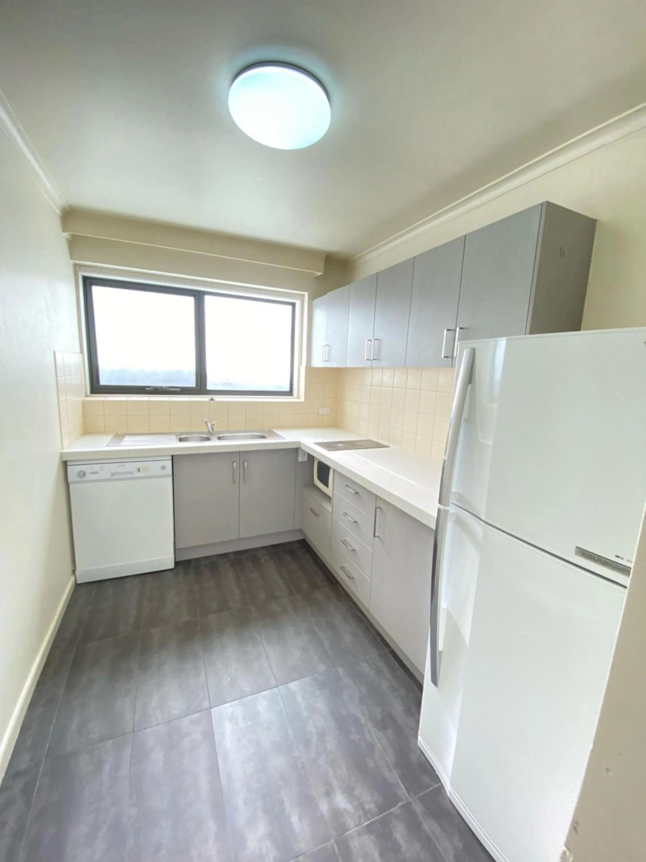 Kitchen or kitchenette in City Edge East Melbourne Apartment Hotel