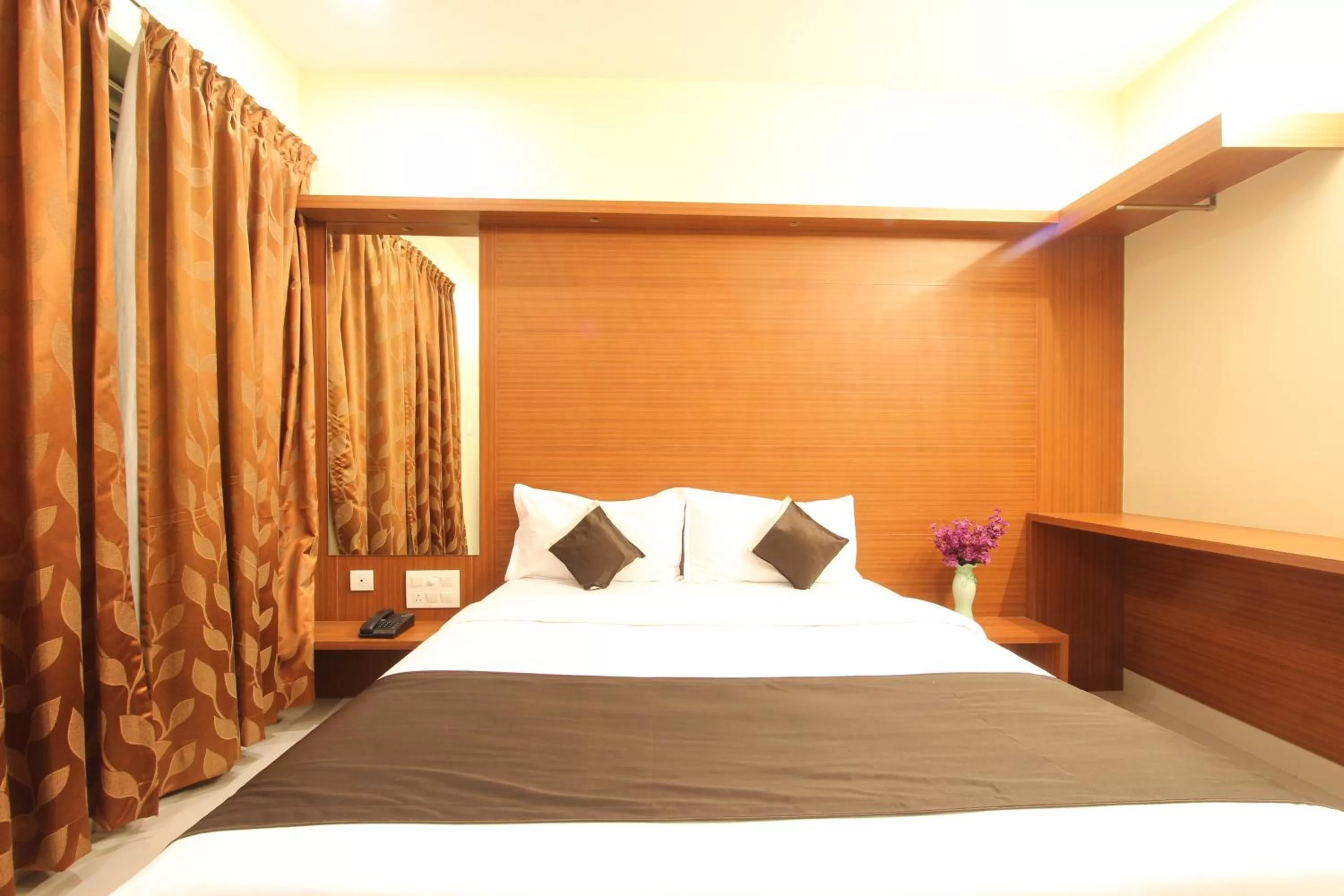 Bed in The Grand Inn Mysore