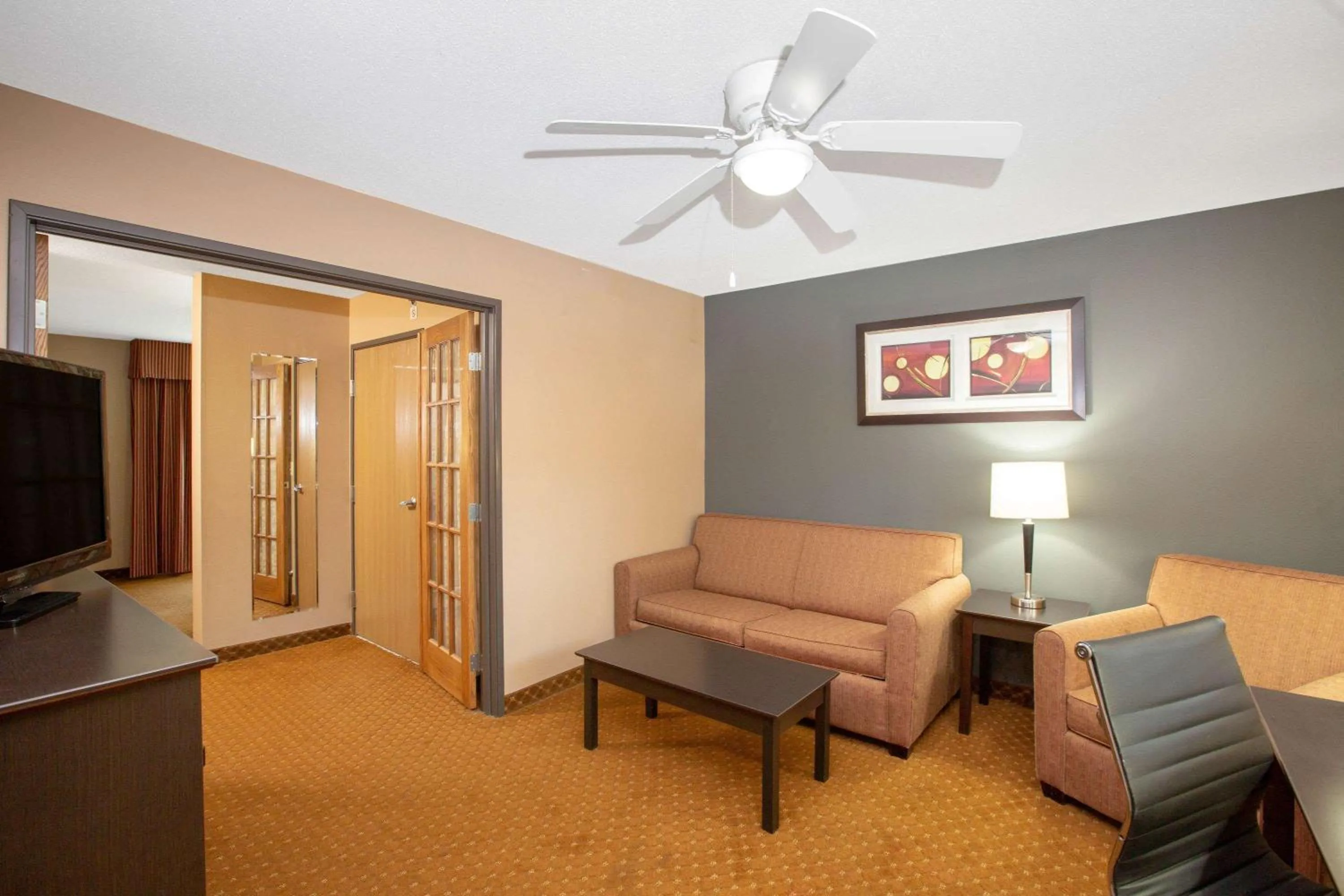 Living room in AmericInn by Wyndham Coralville