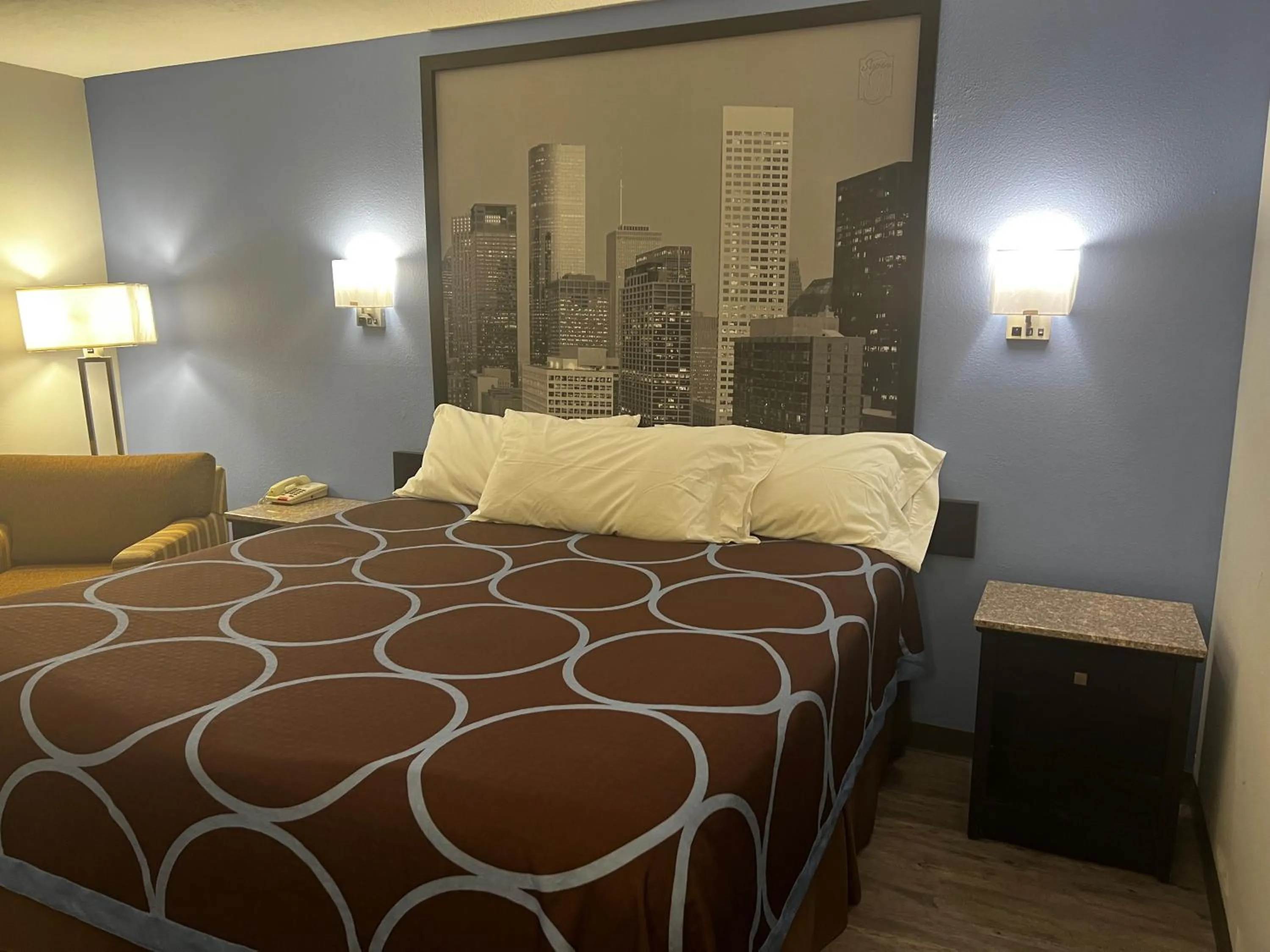 Bed in Super 8 by Wyndham Cleveland TX