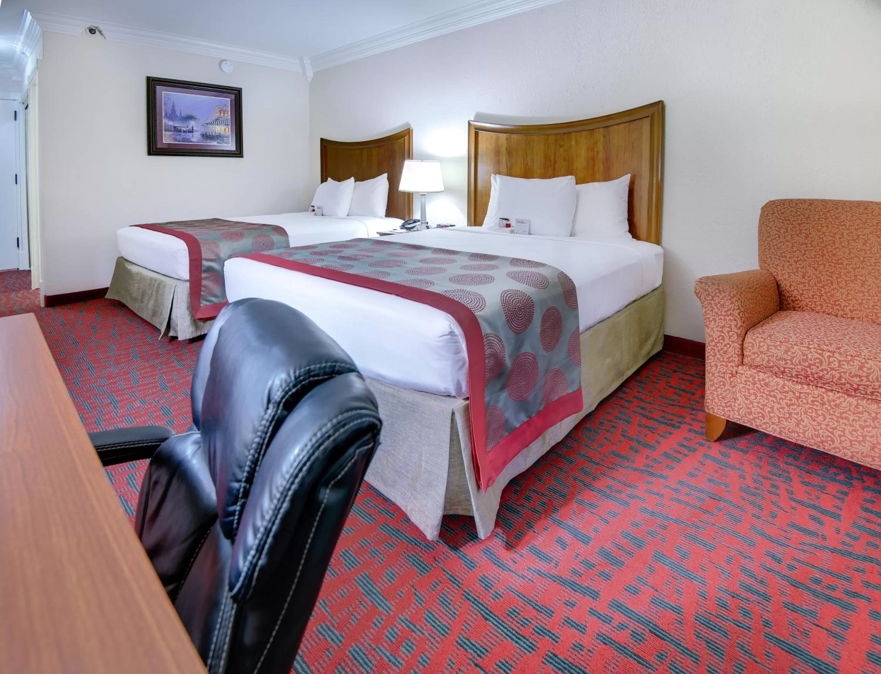 Seating area, Bed in Ramada by Wyndham Metairie New Orleans Airport