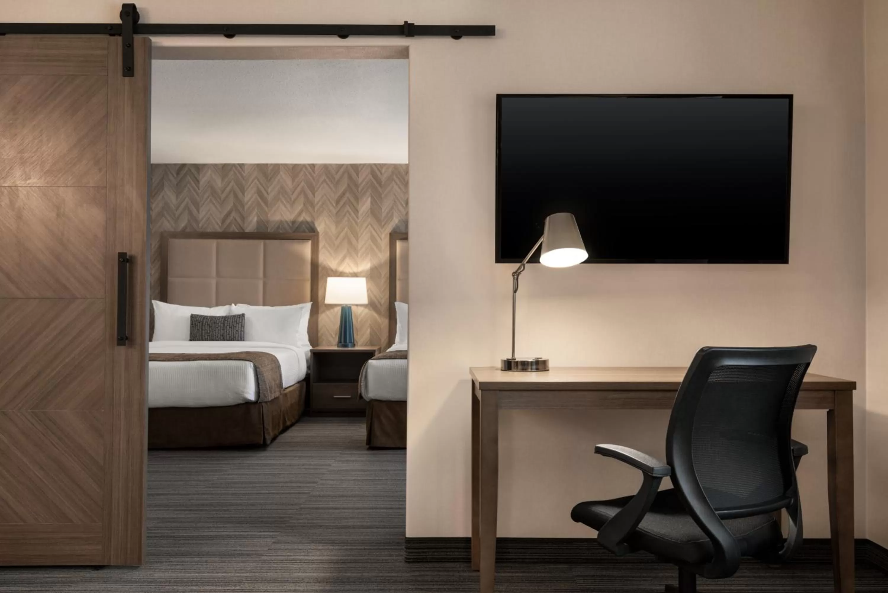 Communal lounge/ TV room, Bed in Ramada by Wyndham Airdrie Hotel & Suites