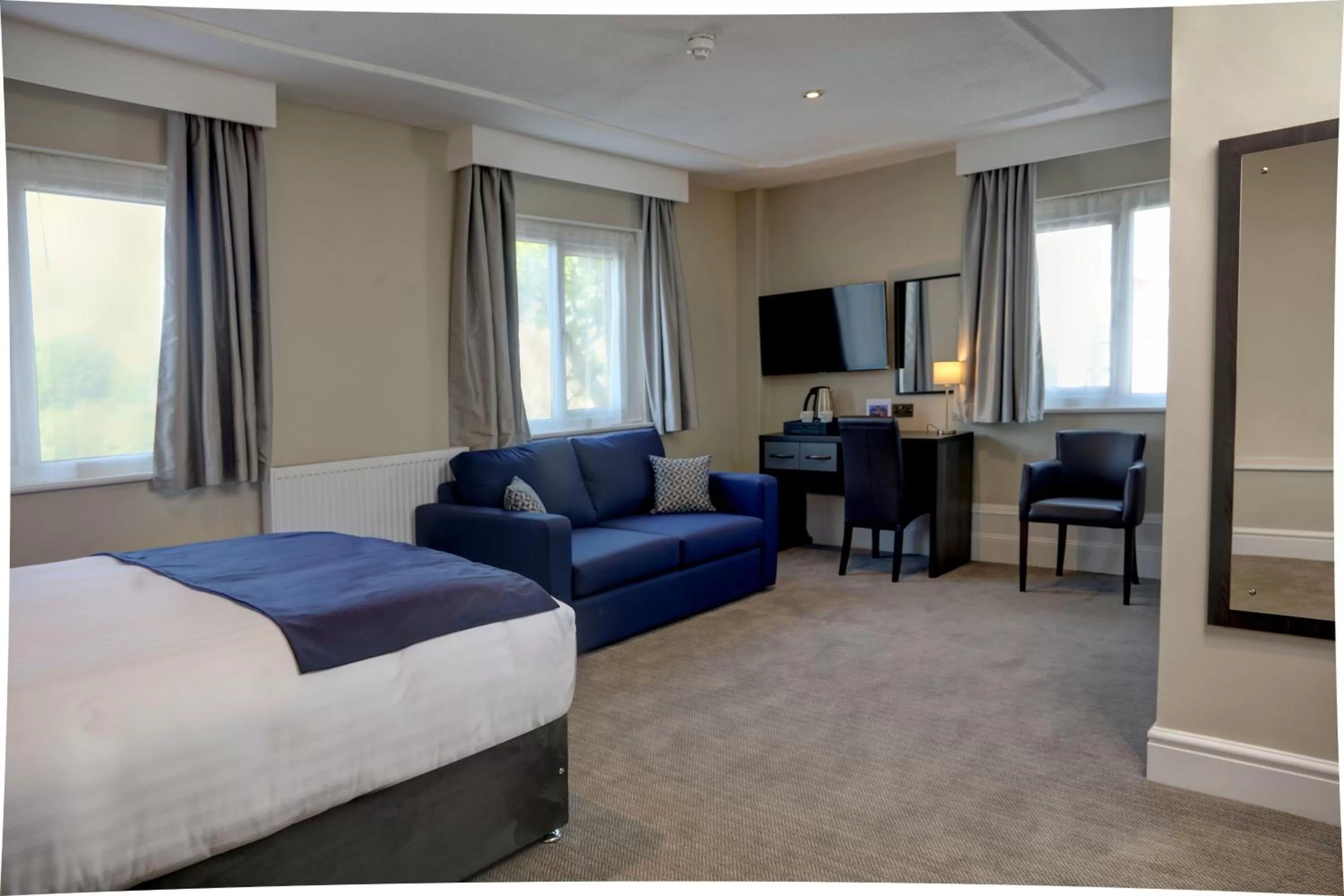 Communal lounge/ TV room in Trafford Hall Hotel Manchester, Trademark Collection by Wyndham