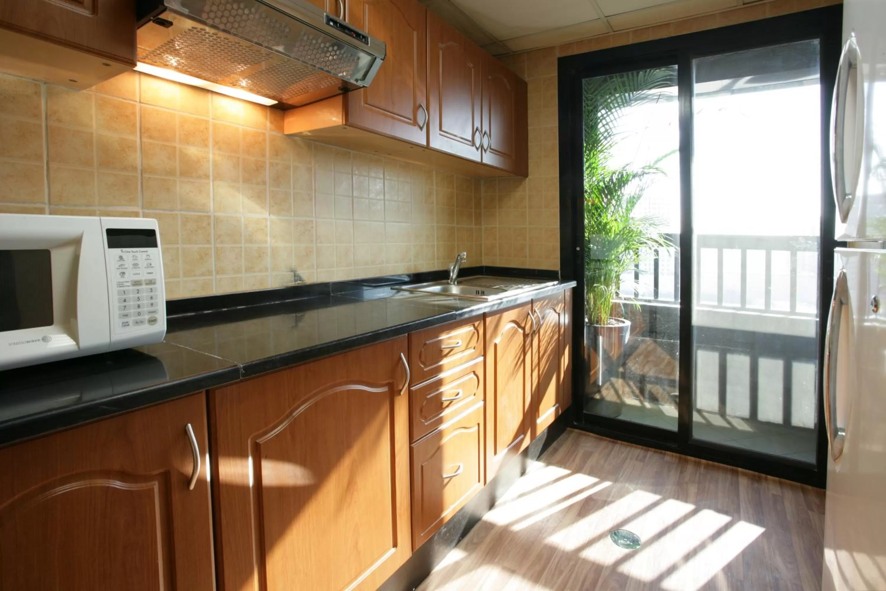 Kitchen or kitchenette in Ramada Hotel & Suites by Wyndham Ajman