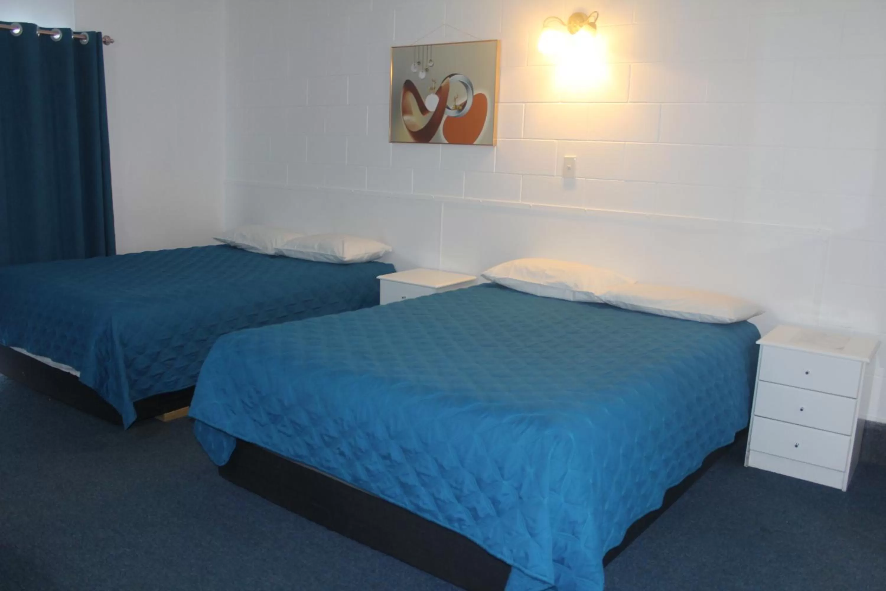 Bed in Golden Glow Motel