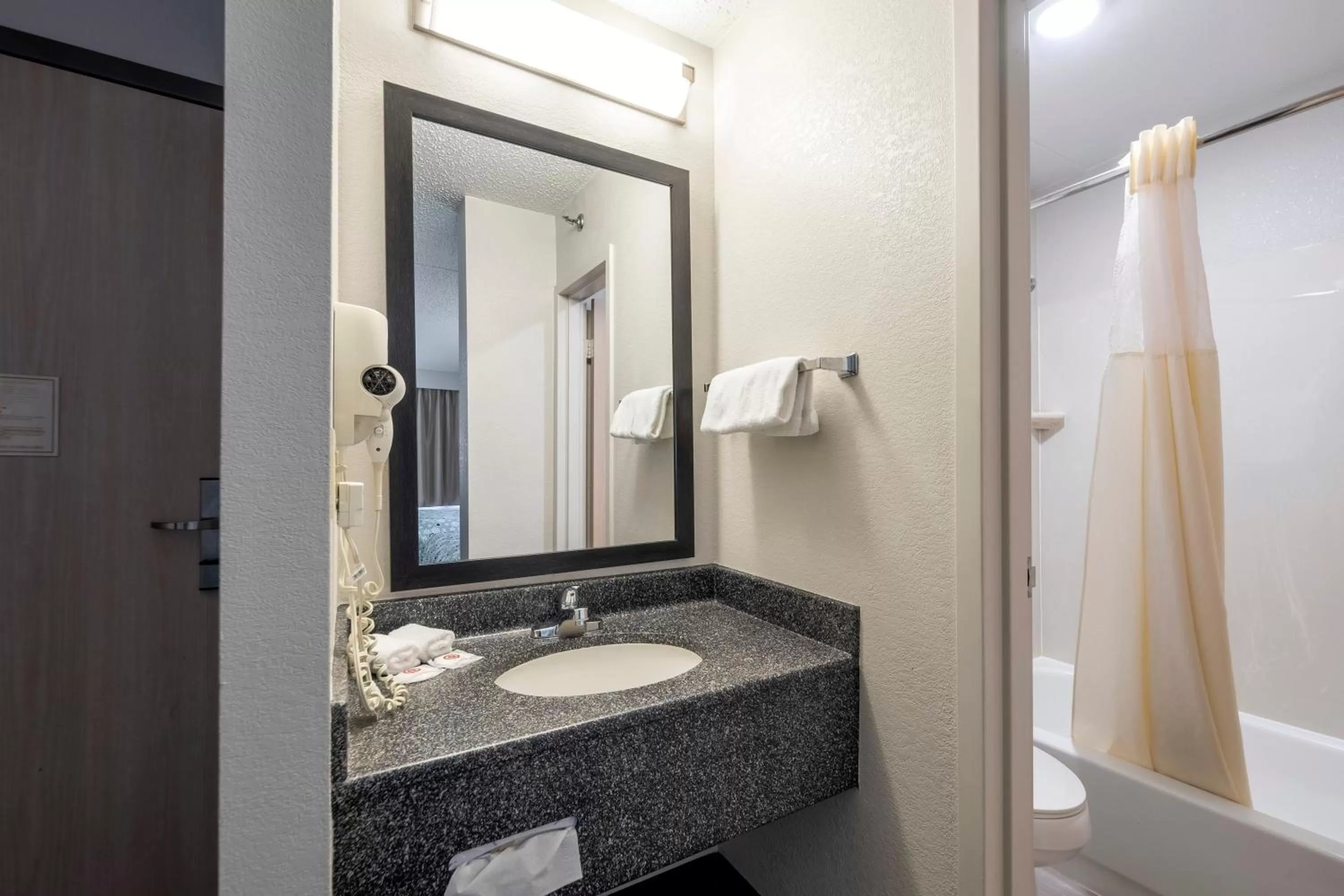 Bathroom in HomeTown Inn by Red Roof East Syracuse