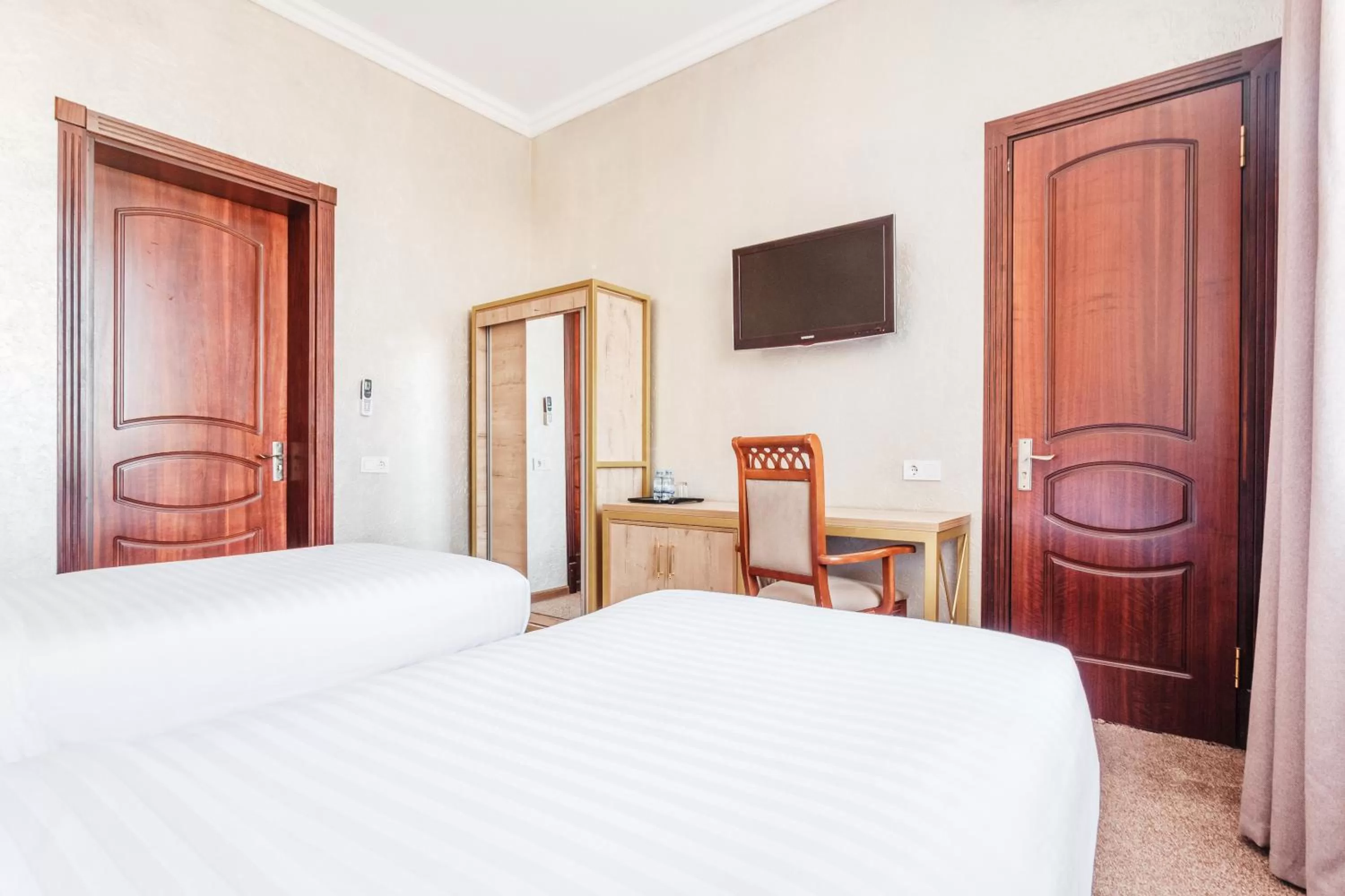 Bed in Western Suites Hotel