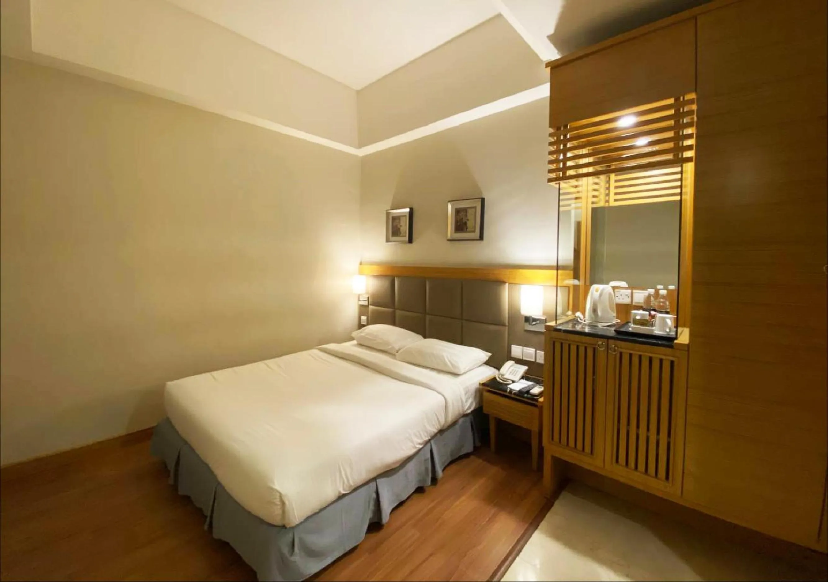 Bed in Crown Garden Hotel