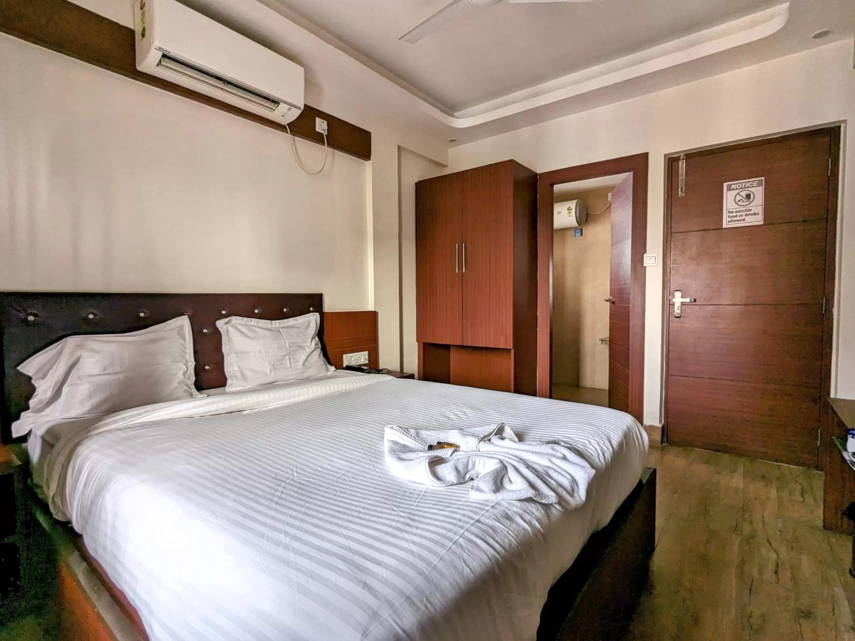 Bed in The Aster Enclave Hotel