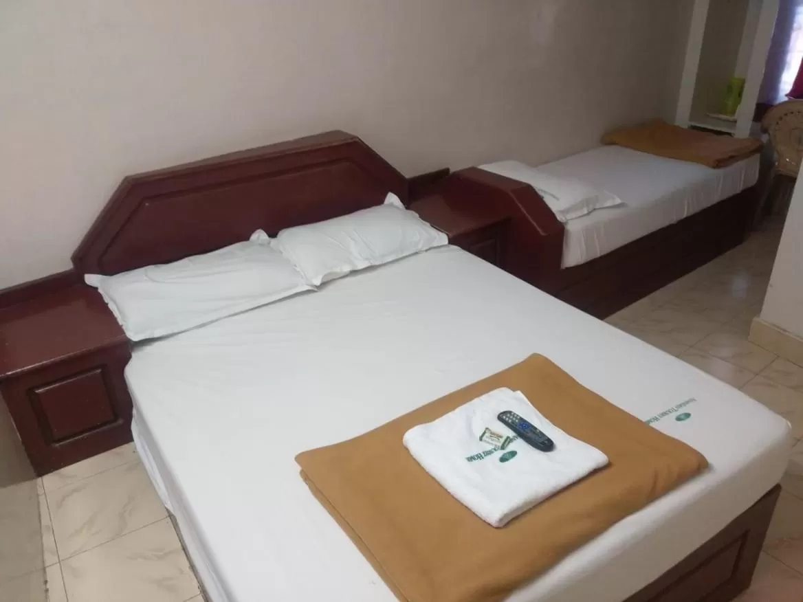 Bed in Anandan Tourist Home