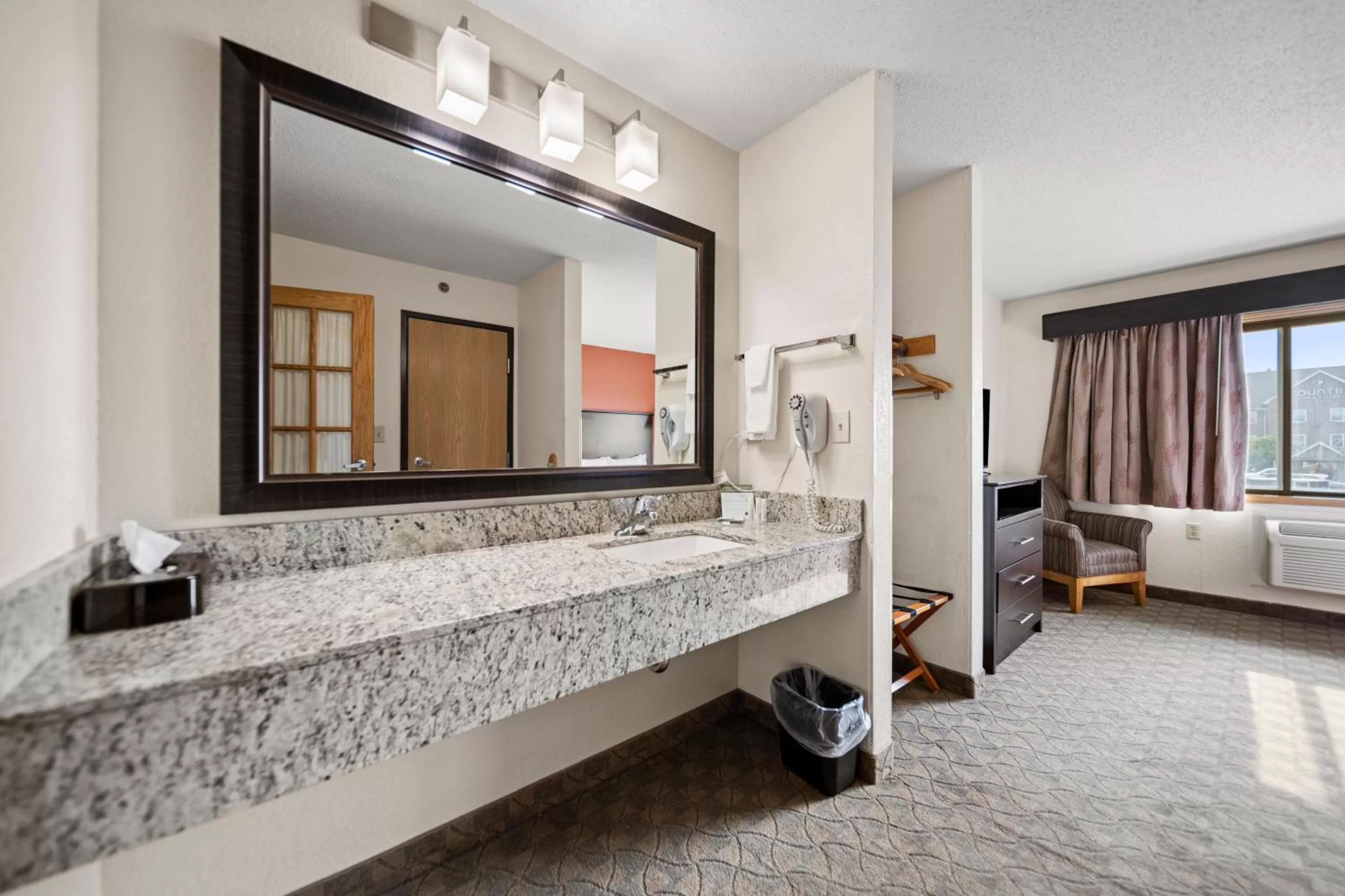 Bathroom, Bed in AmericInn by Wyndham Ames